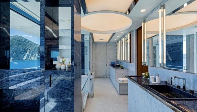 a bathroom with a large glass shower aboard LUMINOSITY Yacht for Sale
