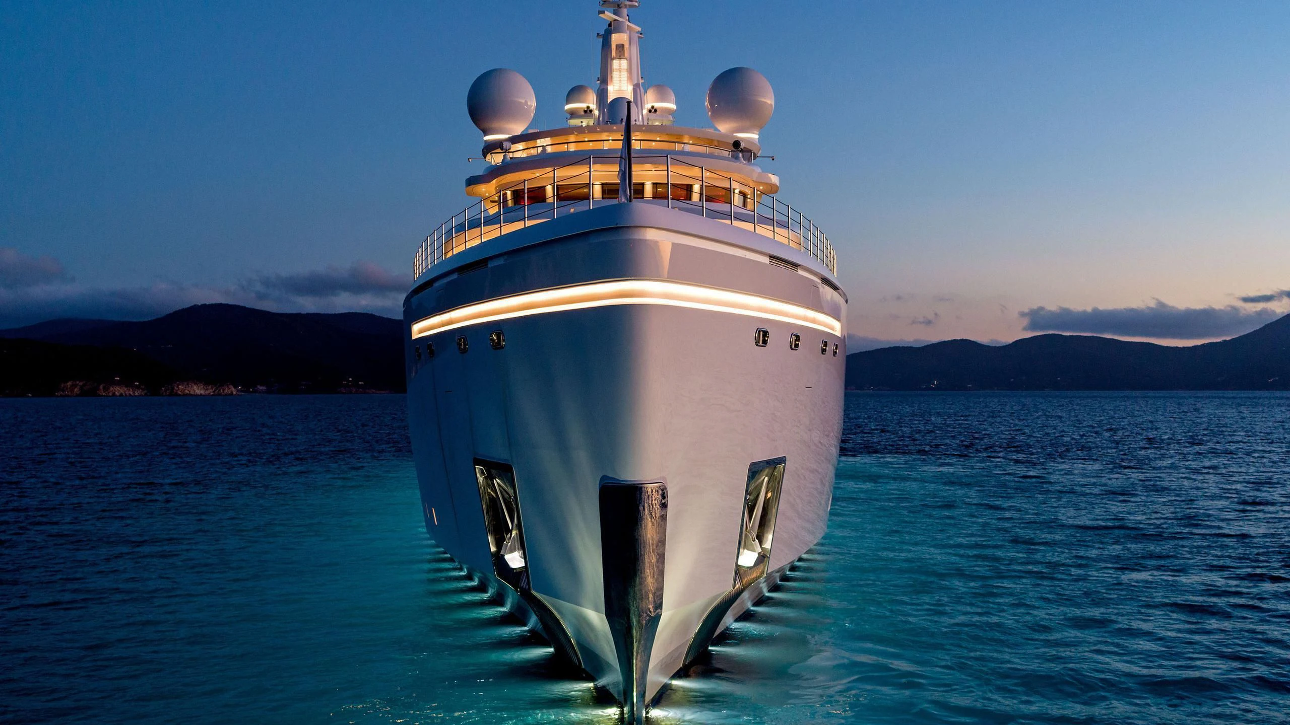 a large white ship in the water aboard LUMINOSITY Yacht for Sale