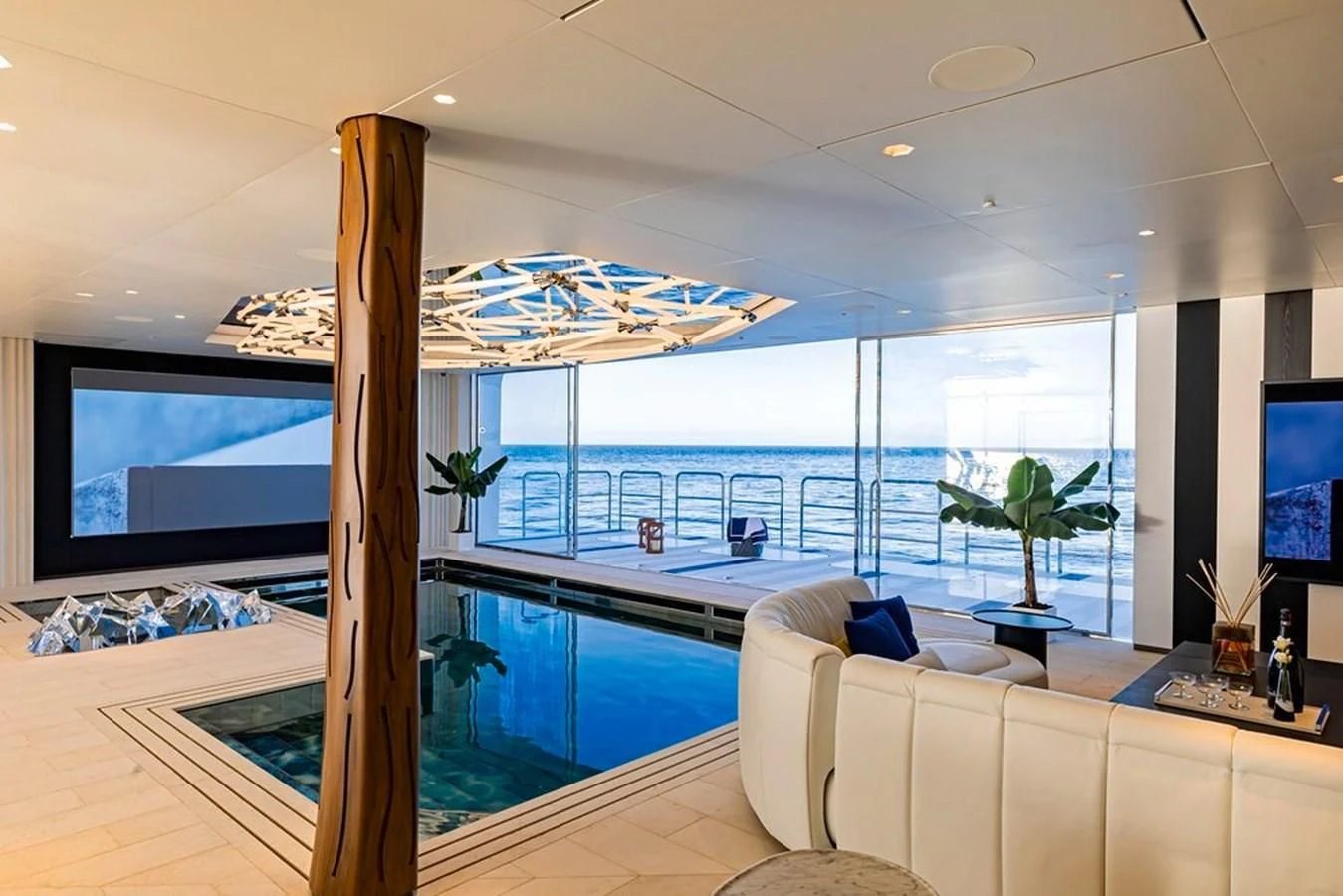 a room with a large window and a pool aboard LUMINOSITY Yacht for Sale