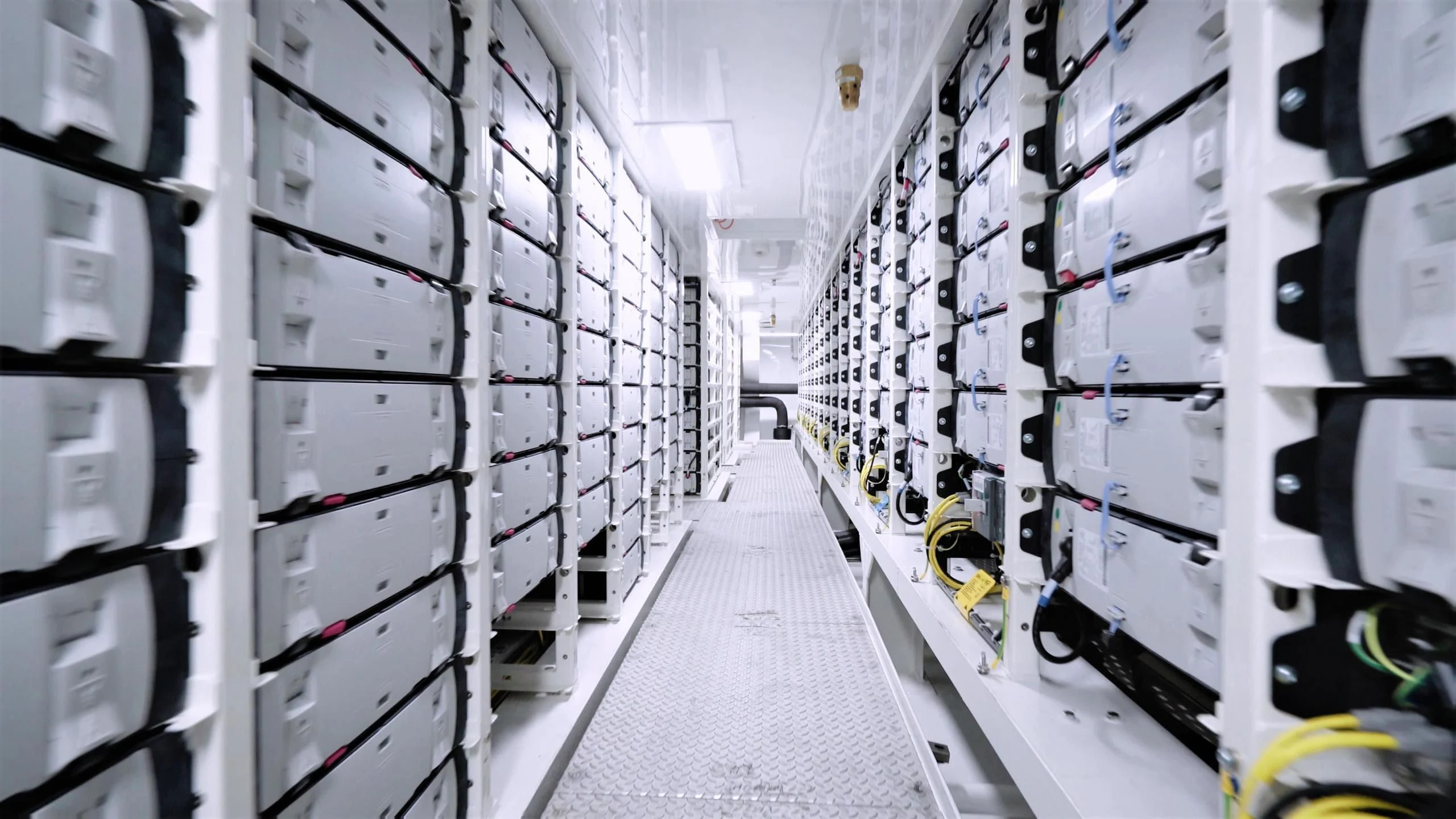 a long hallway with rows of white cabinets aboard LUMINOSITY Yacht for Sale