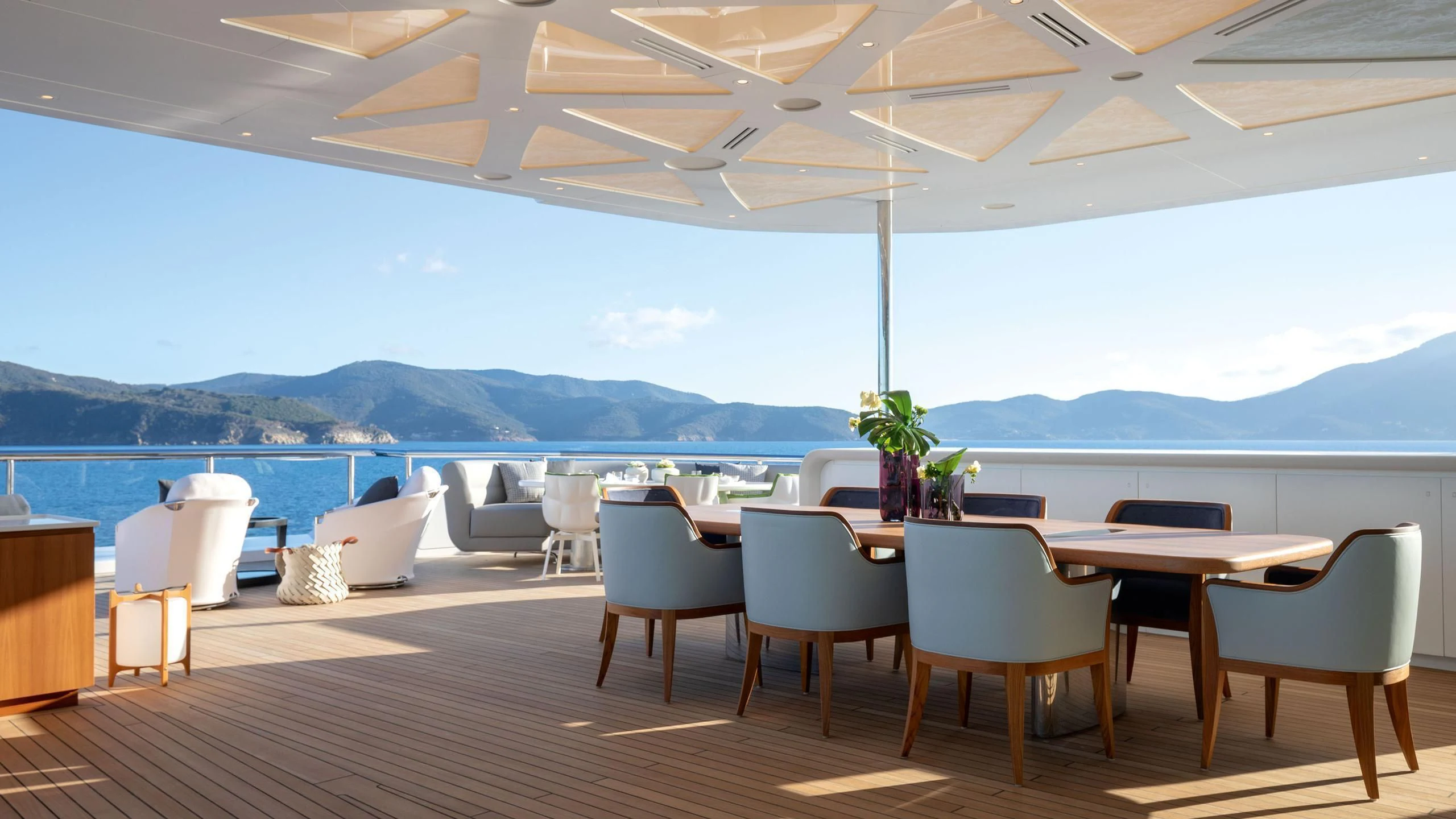 a room with tables and chairs aboard LUMINOSITY Yacht for Sale