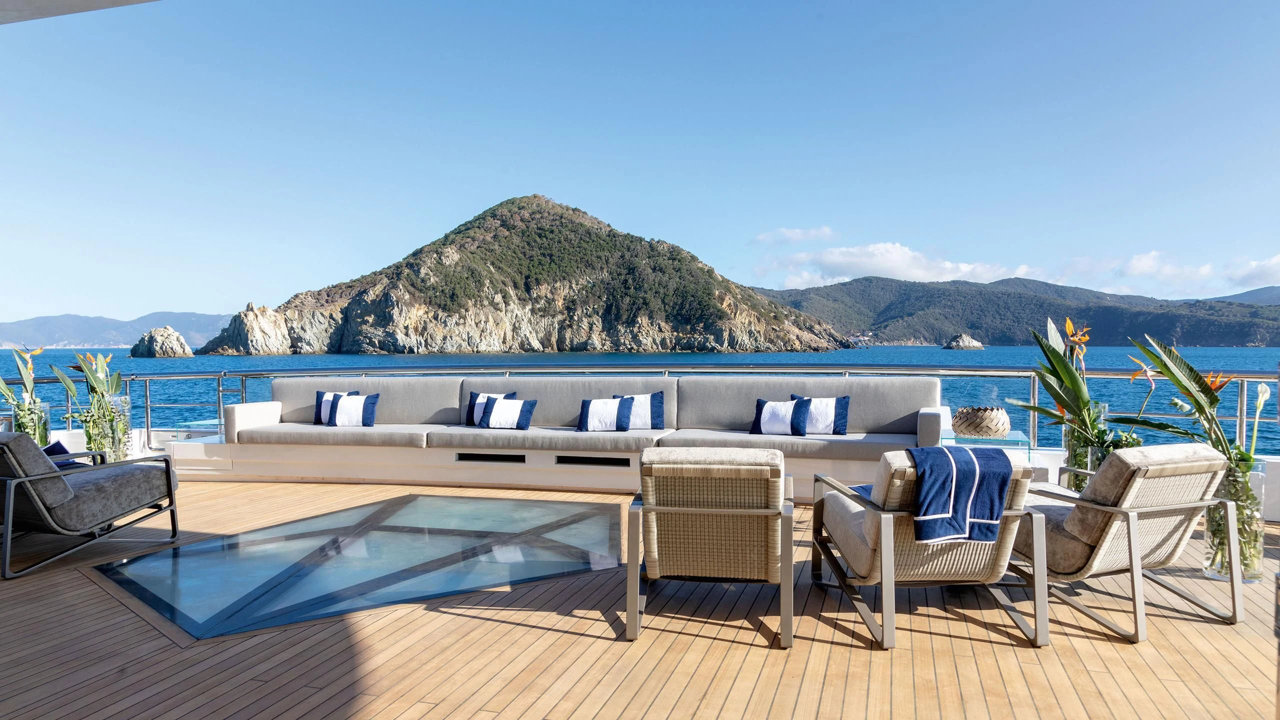 a deck with chairs and a pool aboard LUMINOSITY Yacht for Sale