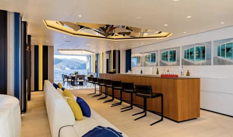 a room with a desk and chairs aboard LUMINOSITY Yacht for Sale