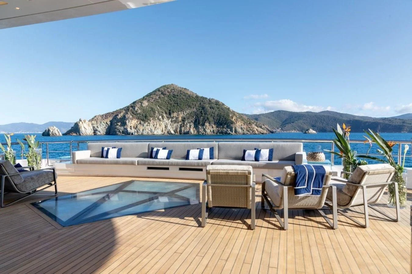 a deck with chairs and a pool aboard LUMINOSITY Yacht for Sale