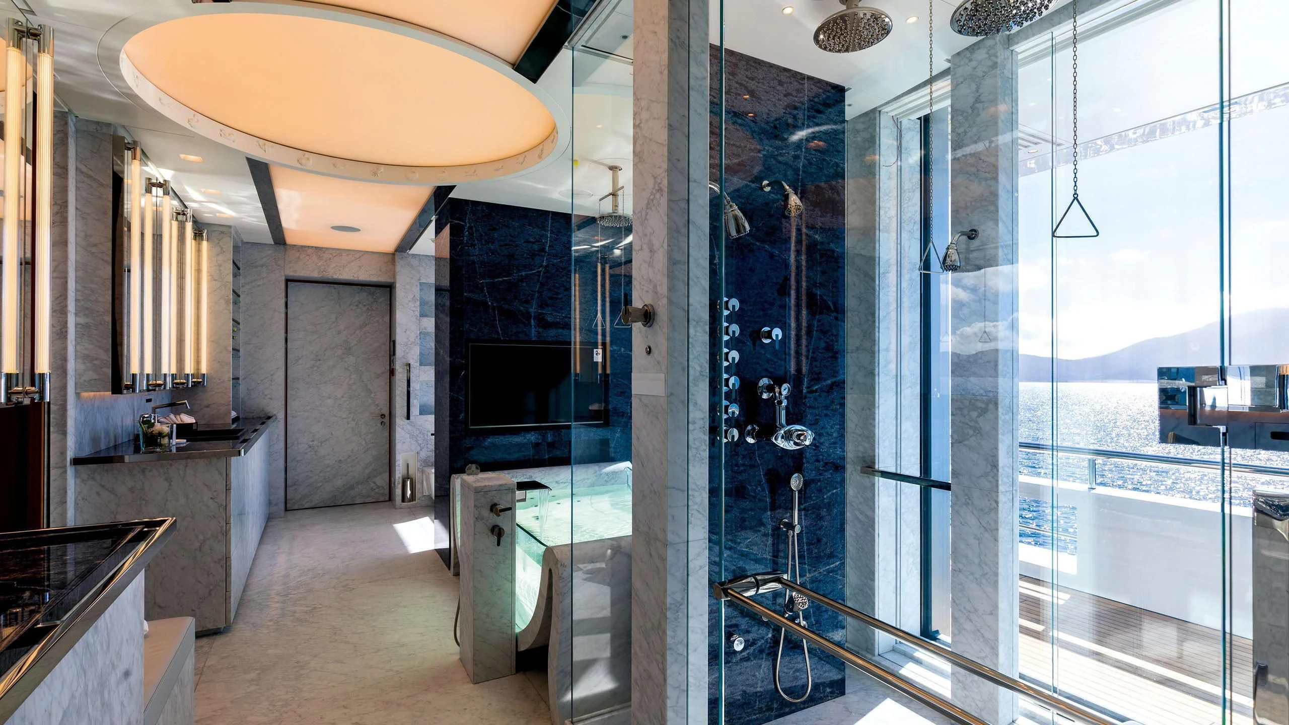 a large bathroom with glass walls aboard LUMINOSITY Yacht for Sale