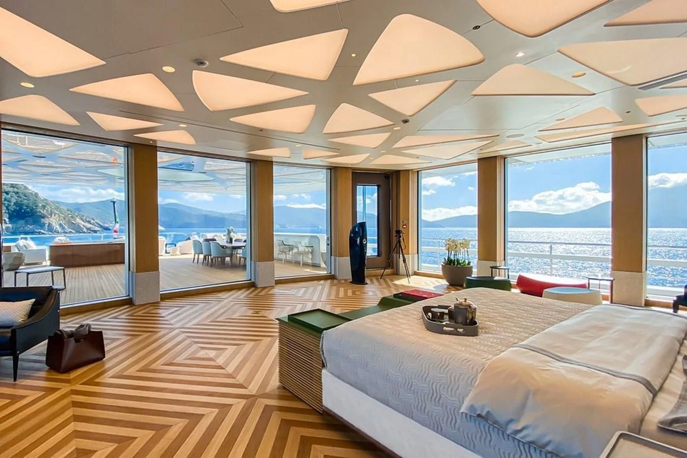 a room with a large bed and a large window aboard LUMINOSITY Yacht for Sale
