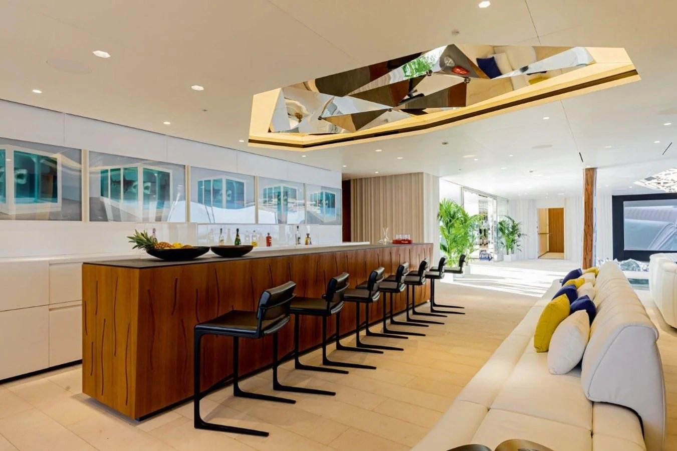 a large room with chairs and a table aboard LUMINOSITY Yacht for Sale