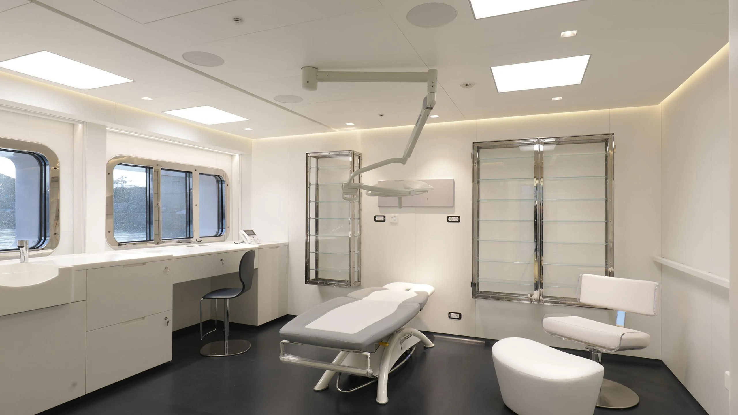 a room with a tub and sinks aboard LUMINOSITY Yacht for Sale