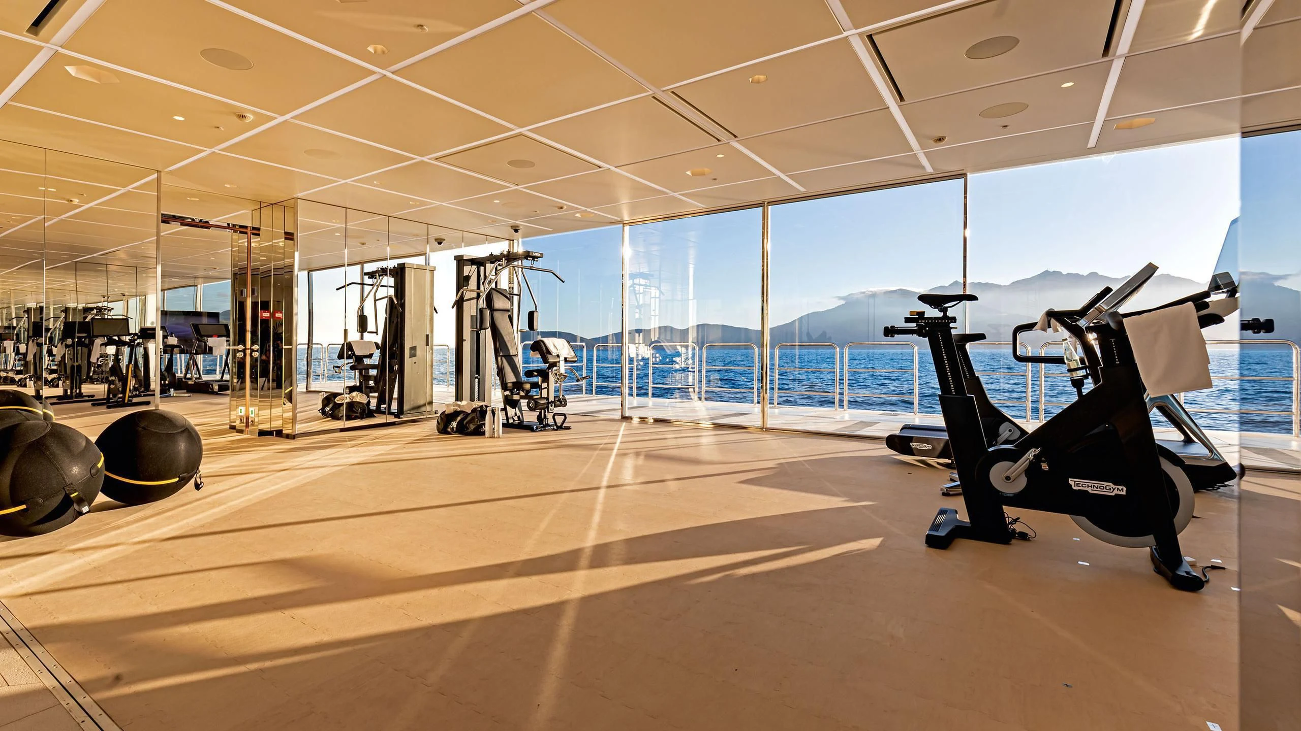 gym with large windows aboard LUMINOSITY Yacht for Sale