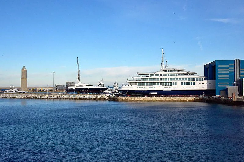 a large cruise ship docked at a port aboard LUMINOSITY Yacht for Sale