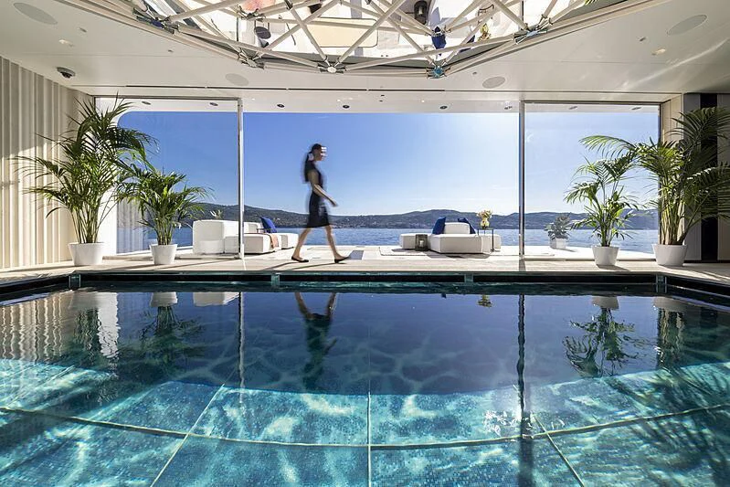 a person standing in a swimming pool aboard LUMINOSITY Yacht for Sale