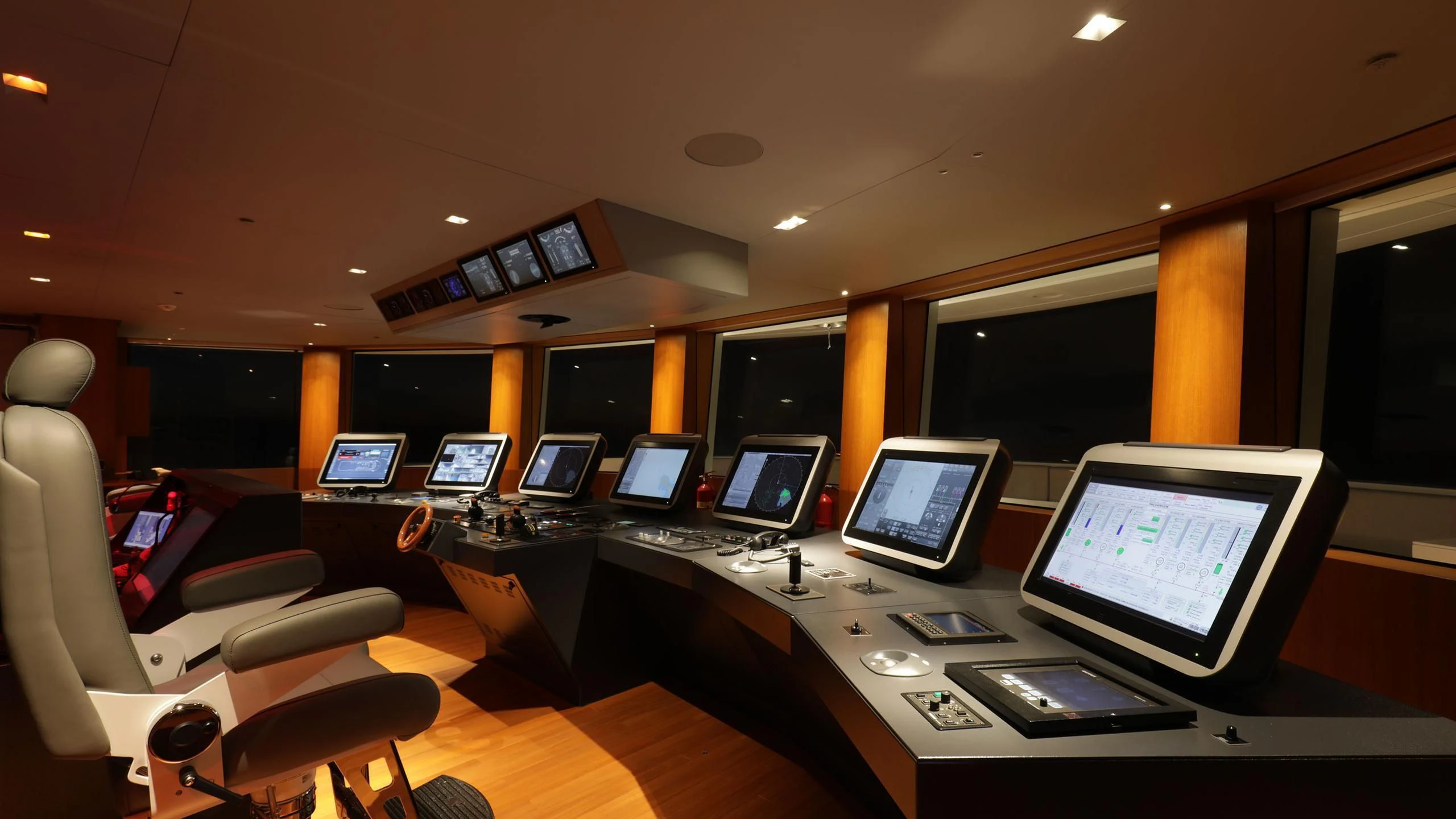 a room with computers and monitors aboard LUMINOSITY Yacht for Sale