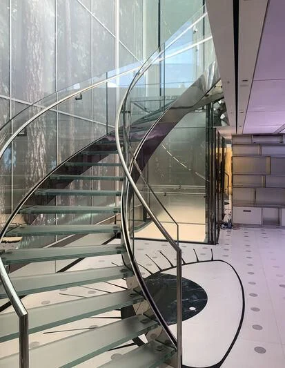 a glass staircase in a building aboard LUMINOSITY Yacht for Sale