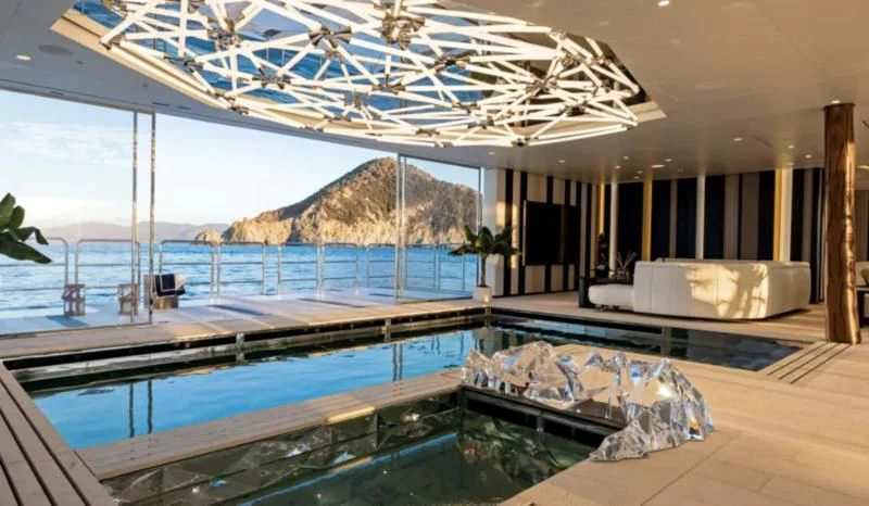 a large room with a pool aboard LUMINOSITY Yacht for Sale