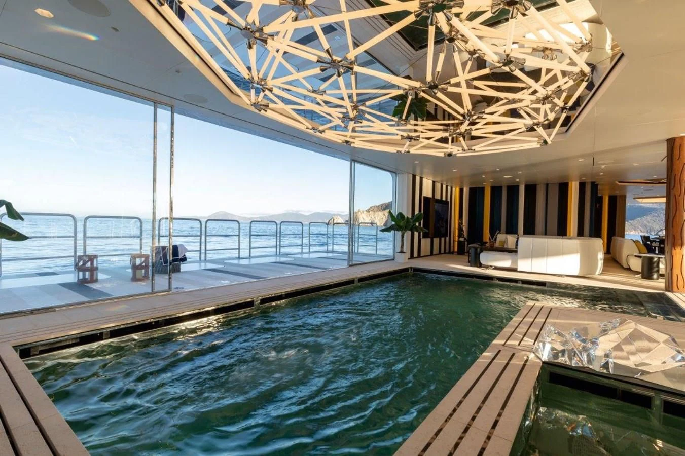 a large swimming pool aboard LUMINOSITY Yacht for Sale