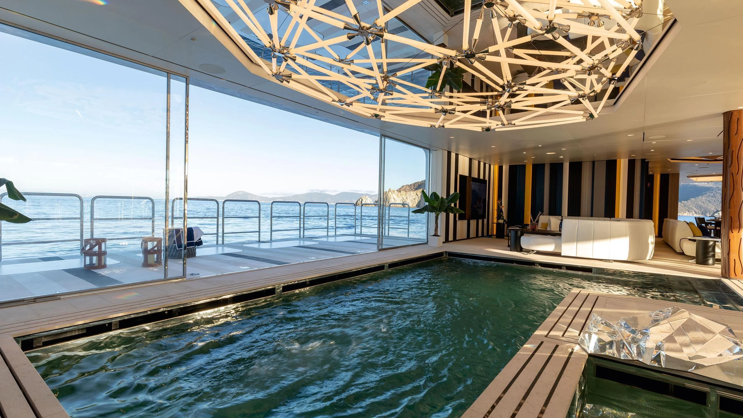a large swimming pool aboard LUMINOSITY Yacht for Sale