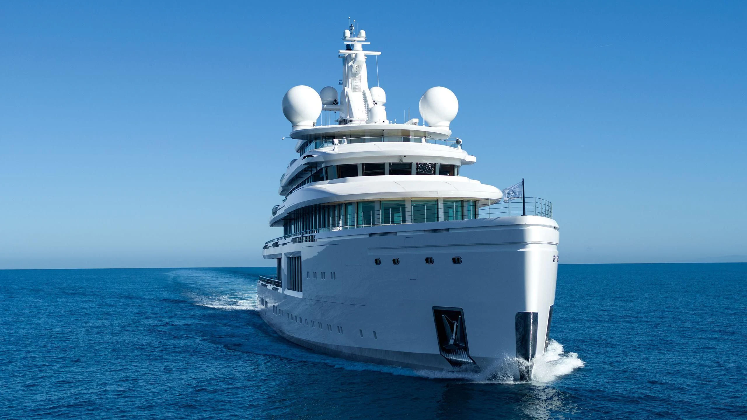 a large white ship in the water aboard LUMINOSITY Yacht for Sale