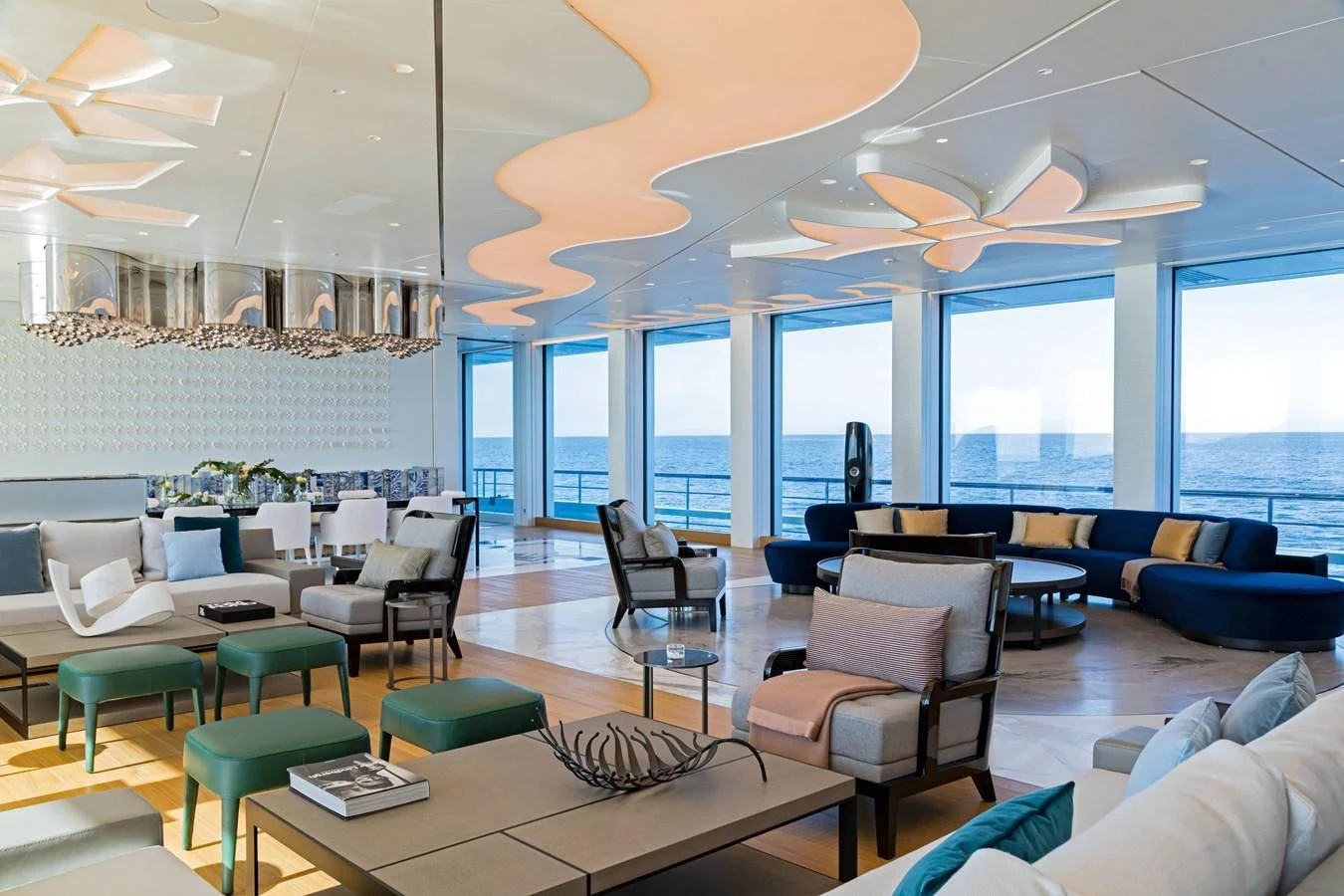 a room with a table chairs and a large window aboard LUMINOSITY Yacht for Sale