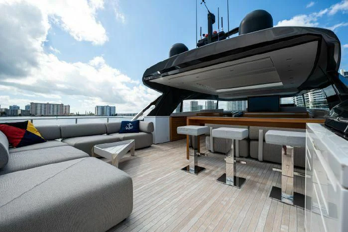 a deck with a large black and white boat on it aboard ABOUT TIME Yacht for Sale