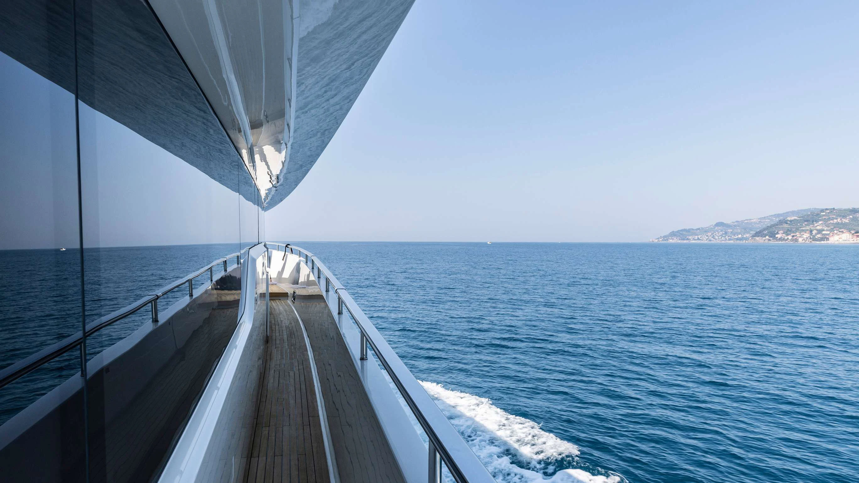 a long wooden walkway over water aboard AMAN Yacht for Sale