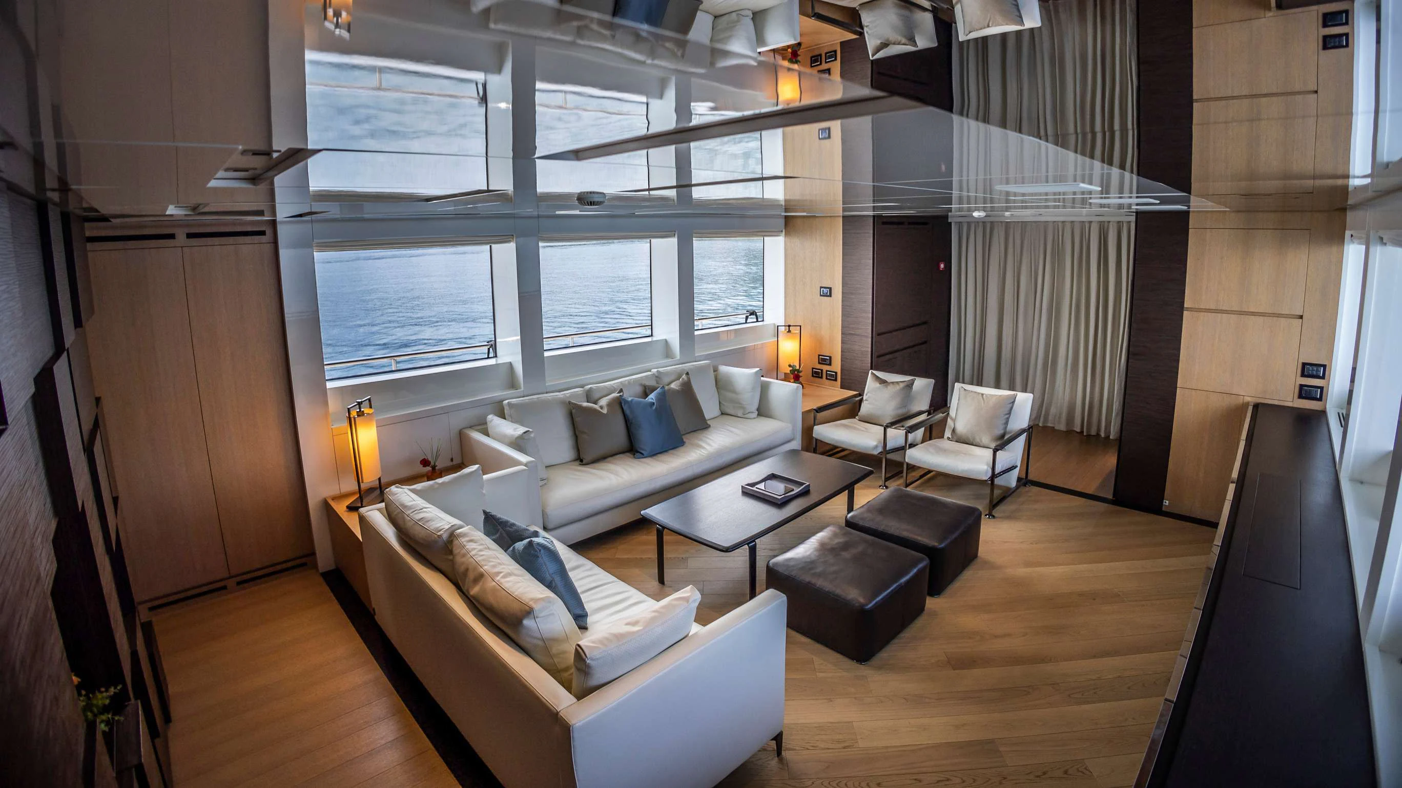 a living room with a couch and a coffee table aboard AMAN Yacht for Sale