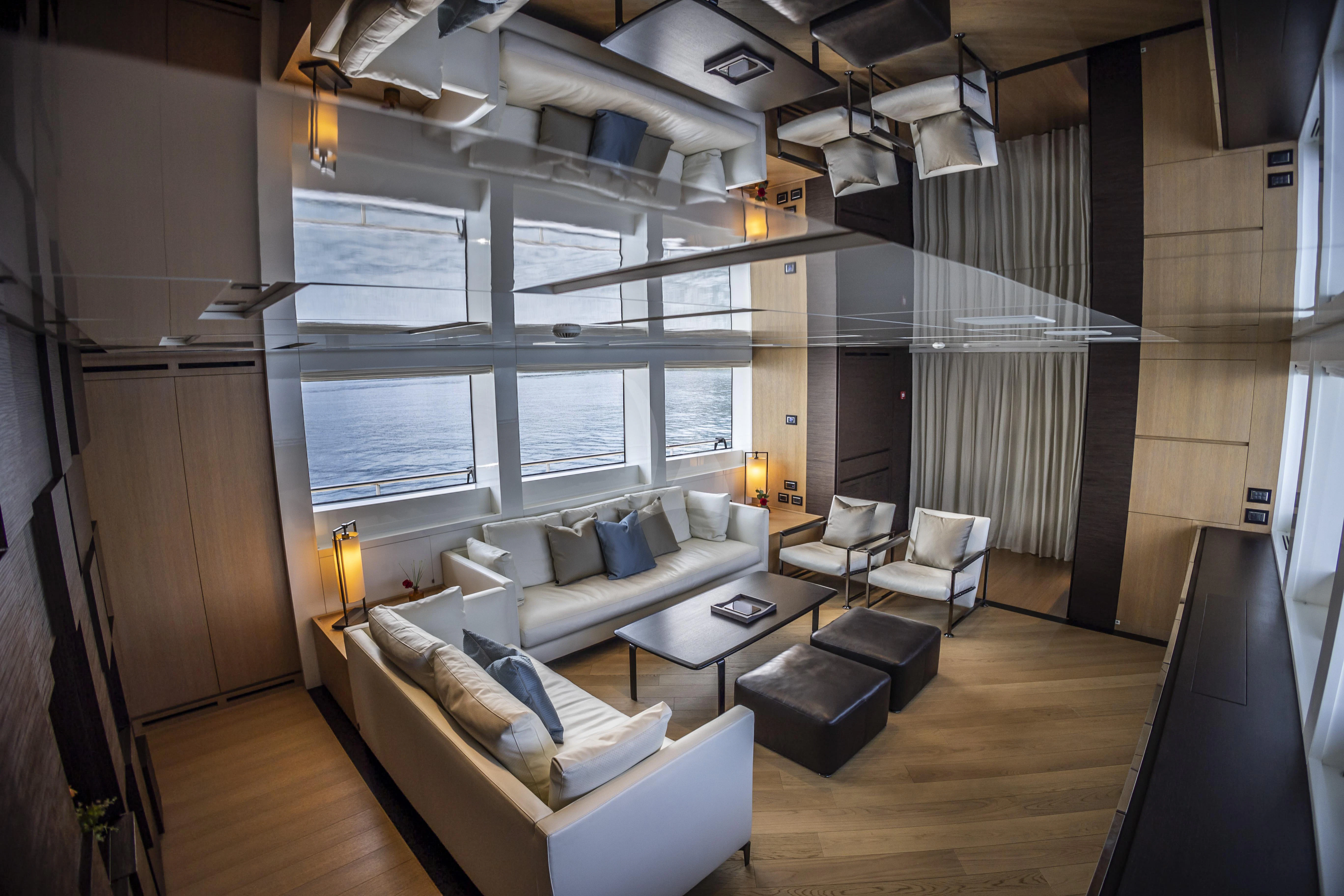 a living room with a large window aboard AMAN Yacht for Sale