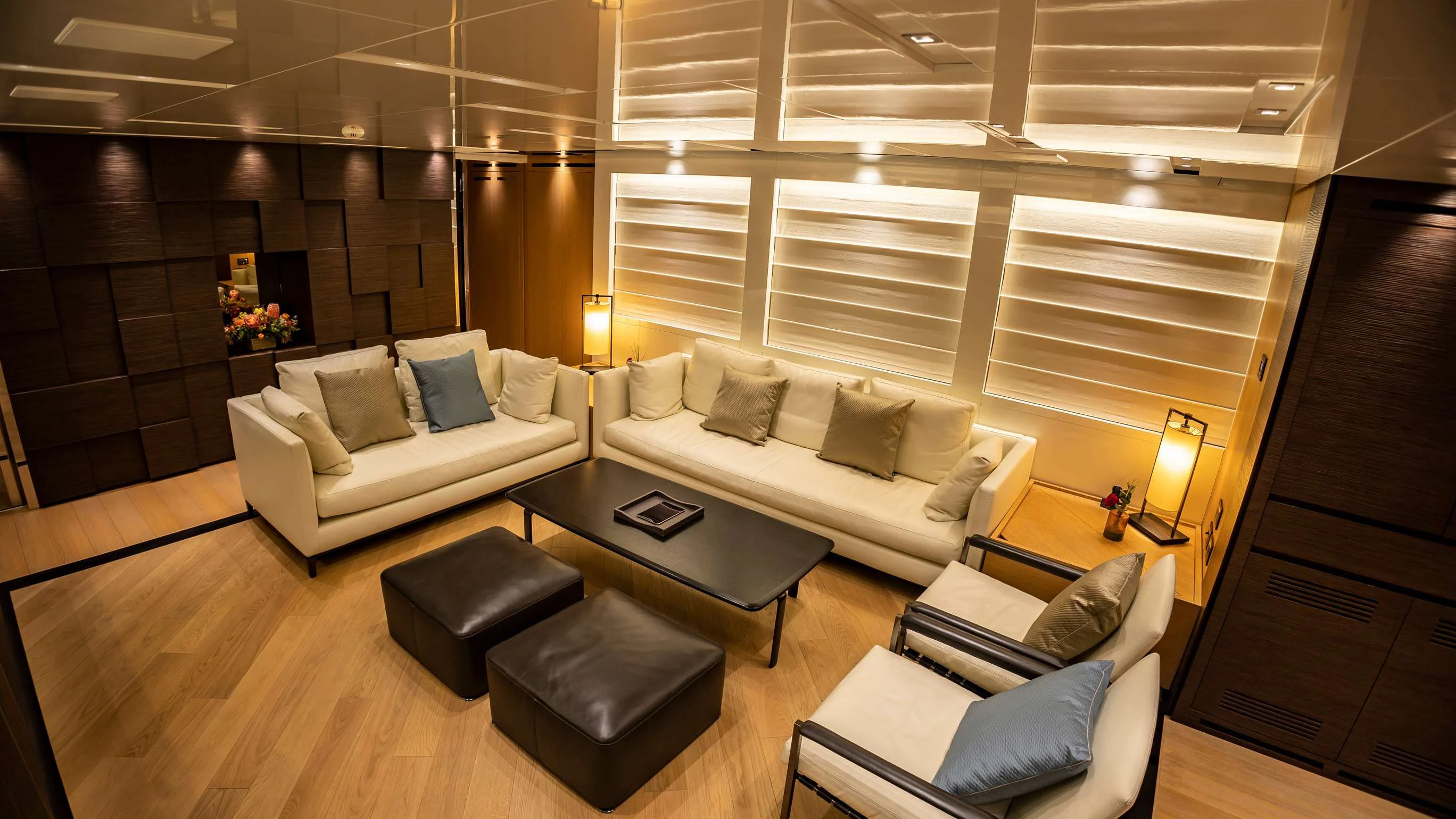a living room with a couch and a table aboard AMAN Yacht for Sale