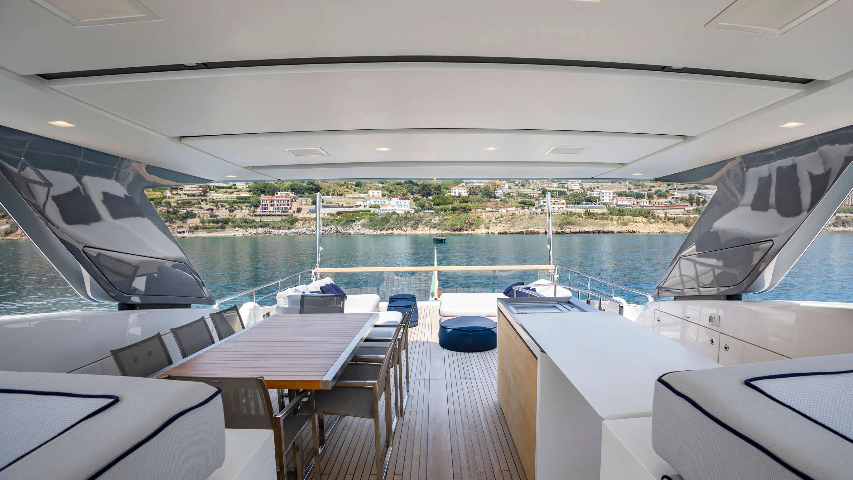 a deck with a view of a city and a body of water aboard AMAN Yacht for Sale