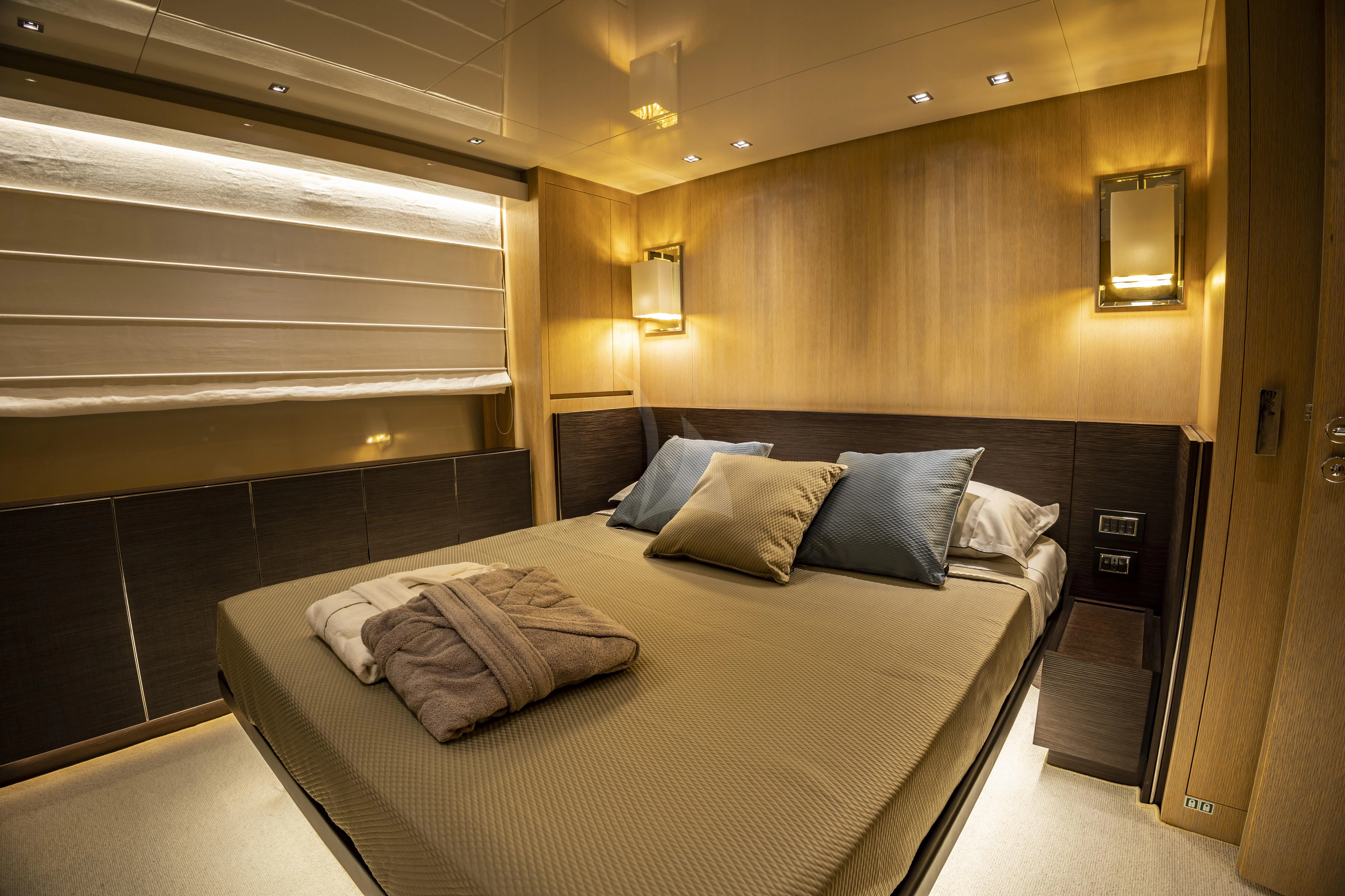a bed in a room aboard AMAN Yacht for Sale