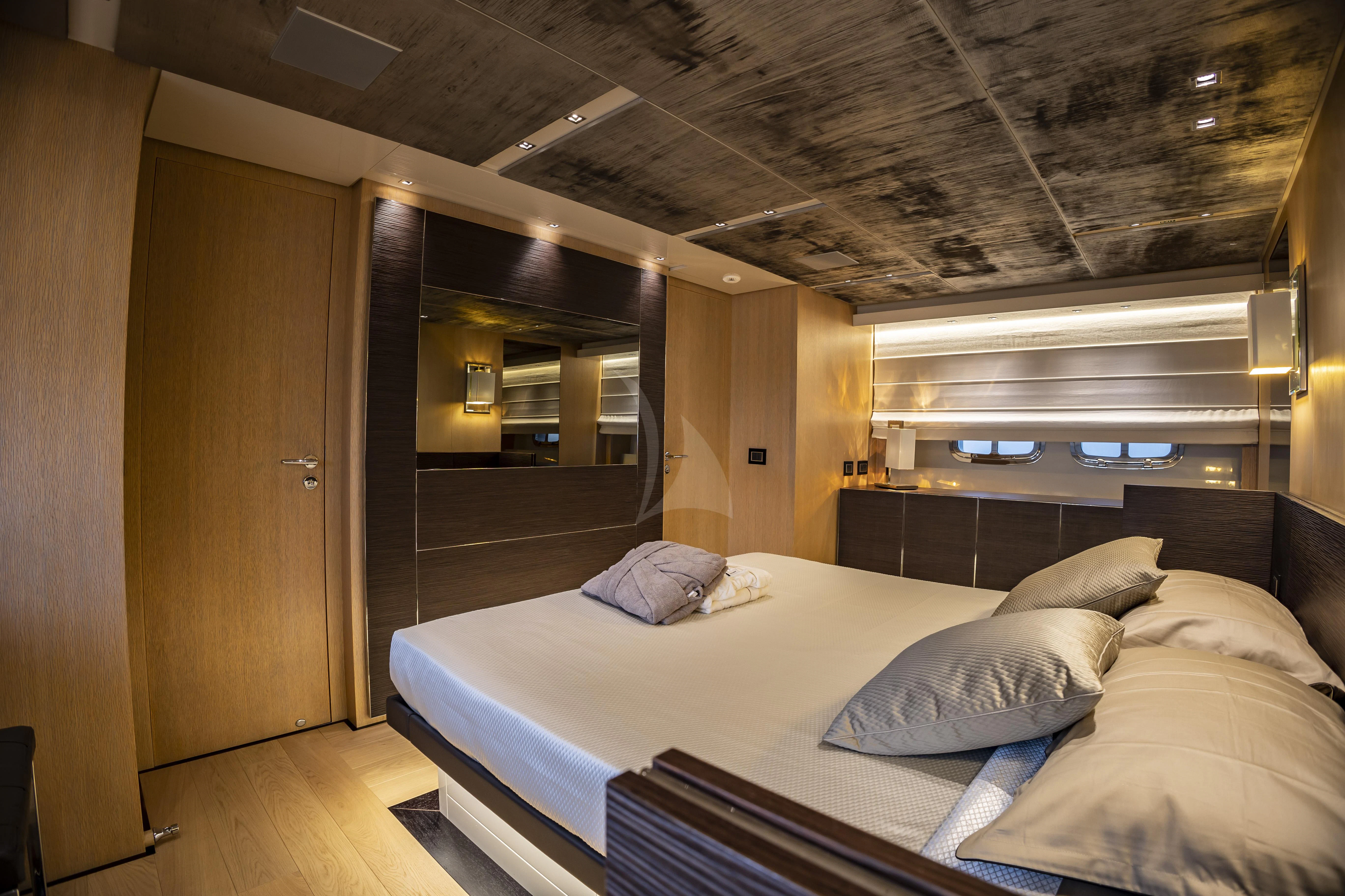 a room with a bed and a desk aboard AMAN Yacht for Sale