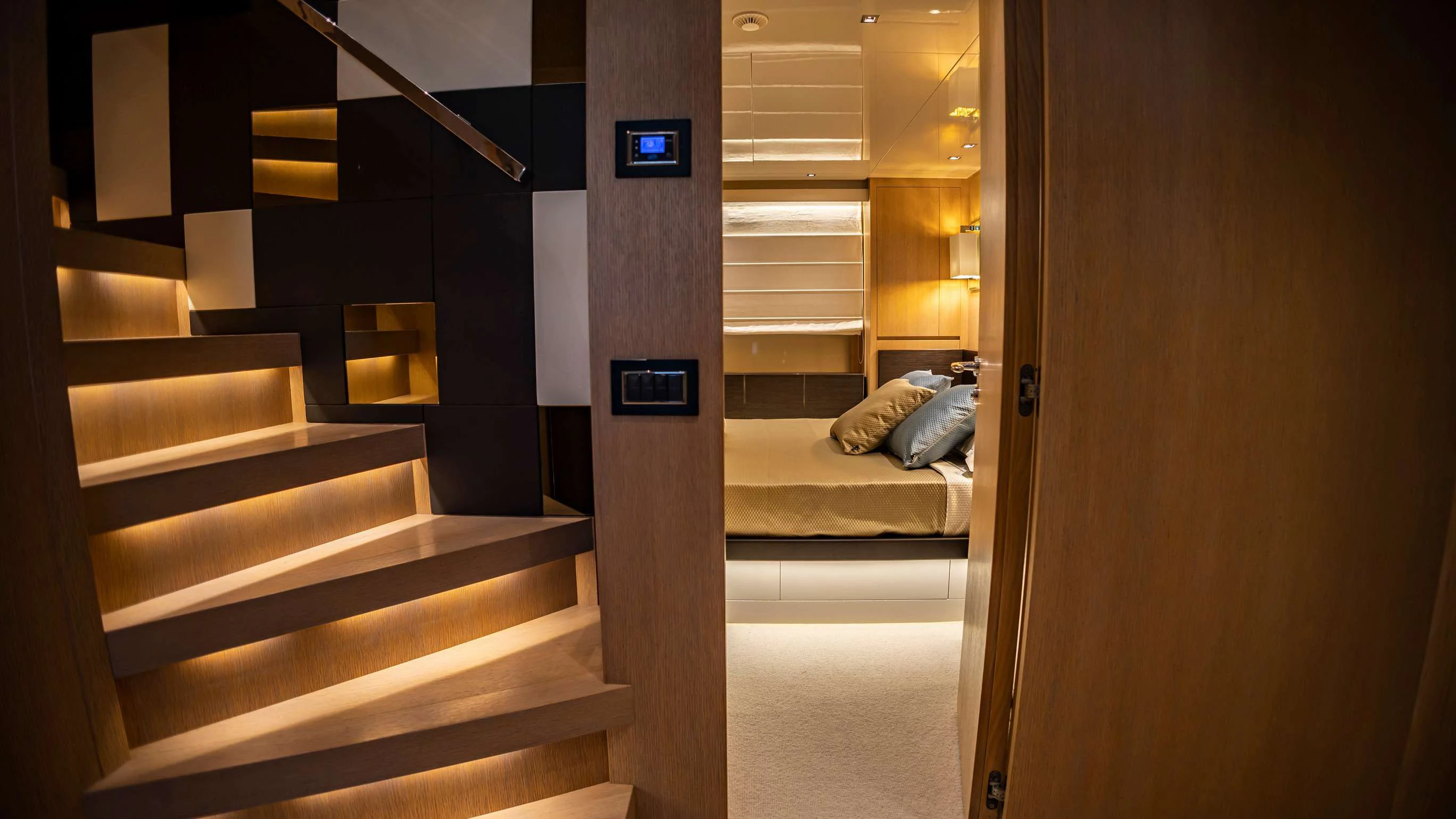 a room with a bed and a door aboard AMAN Yacht for Sale