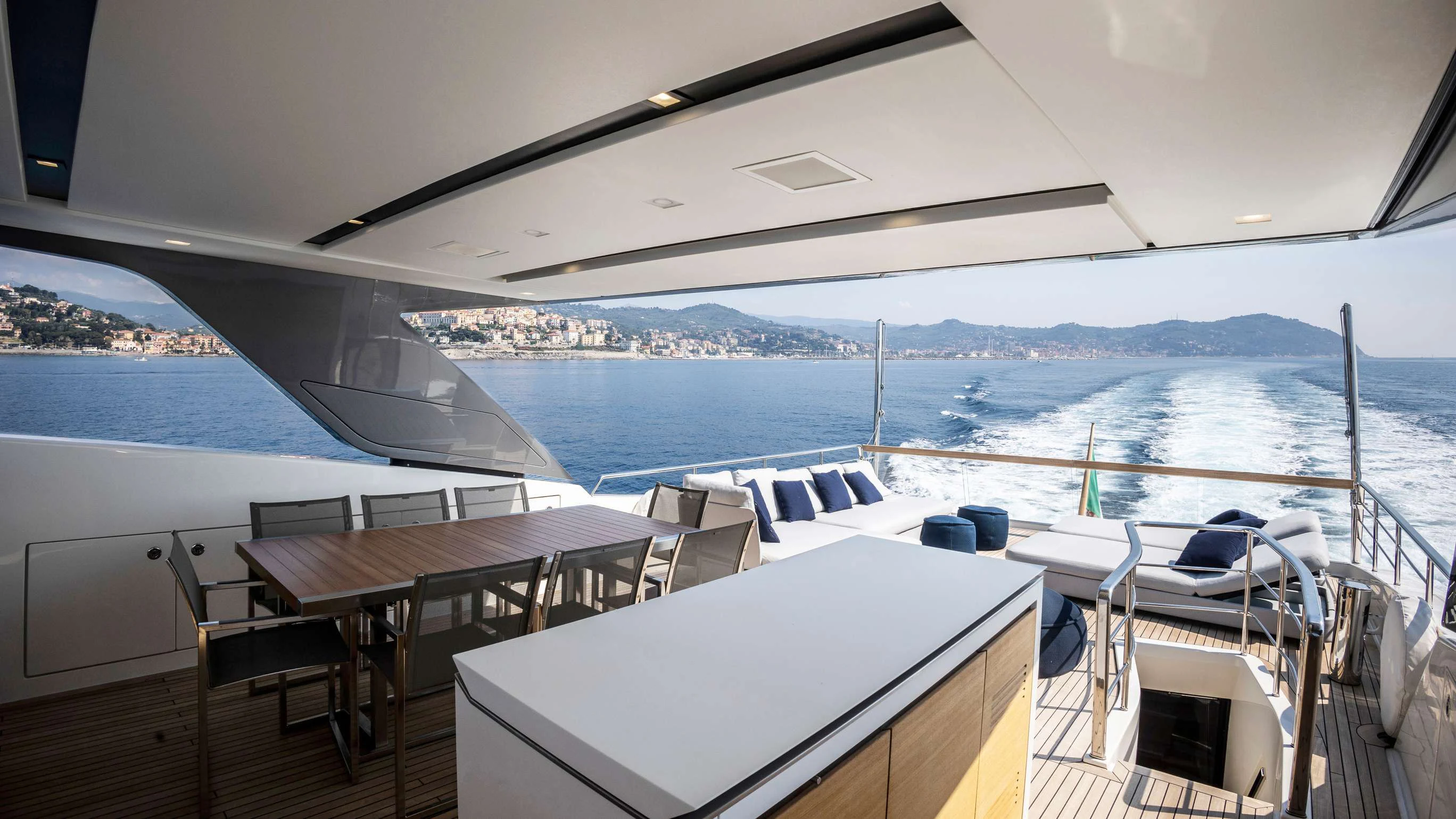 a deck with a table and chairs on it aboard AMAN Yacht for Sale
