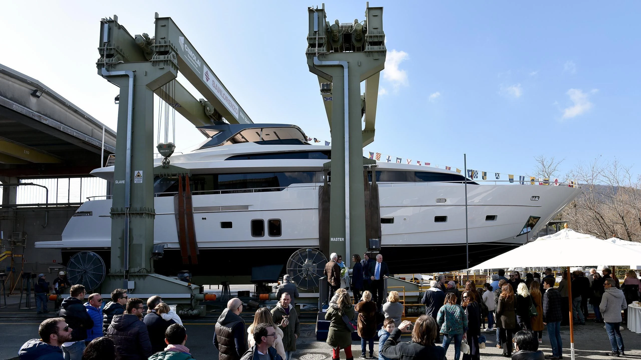 a crowd of people next to a large white boat aboard AMAN Yacht for Sale