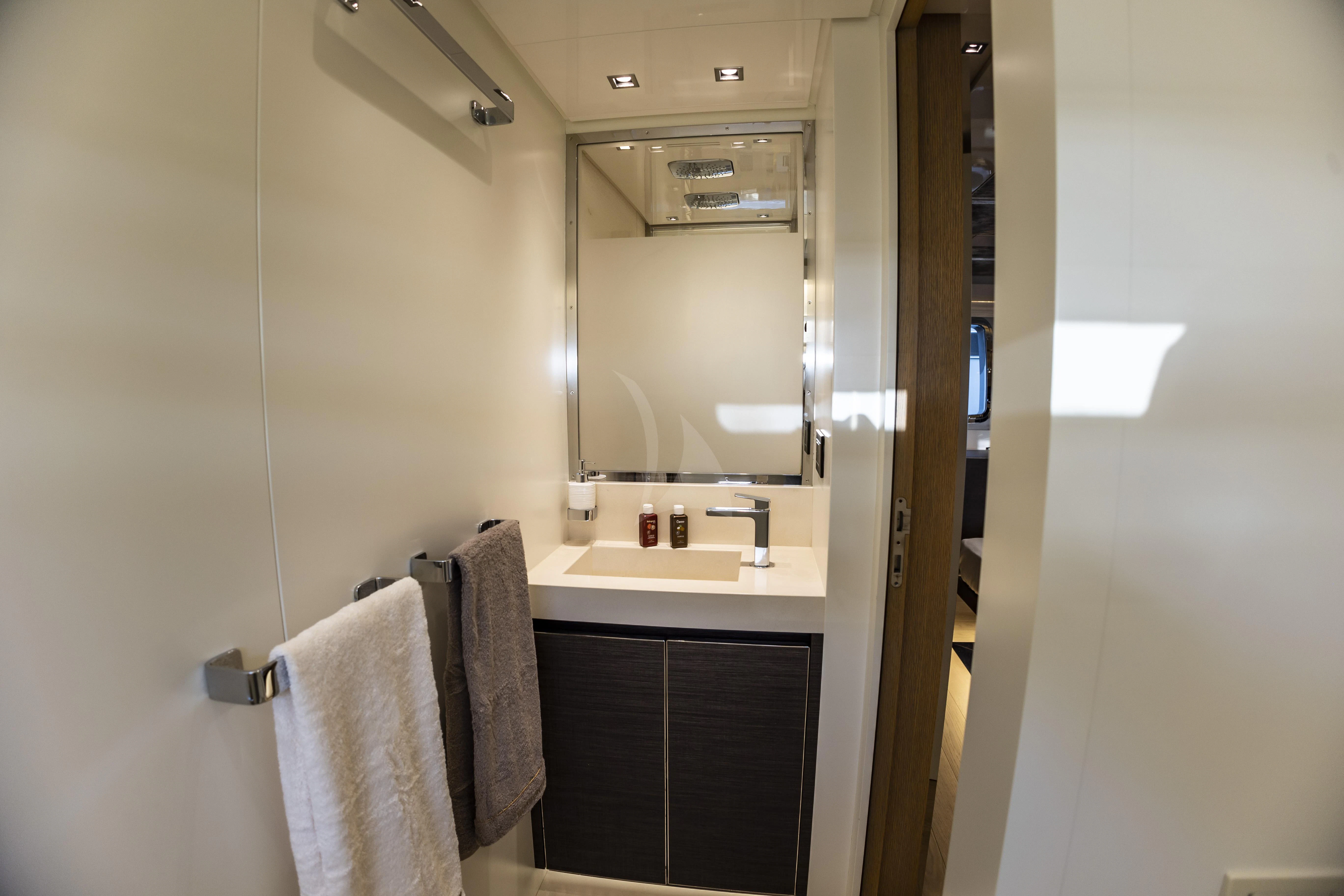 a bathroom with a sink and a mirror aboard AMAN Yacht for Sale