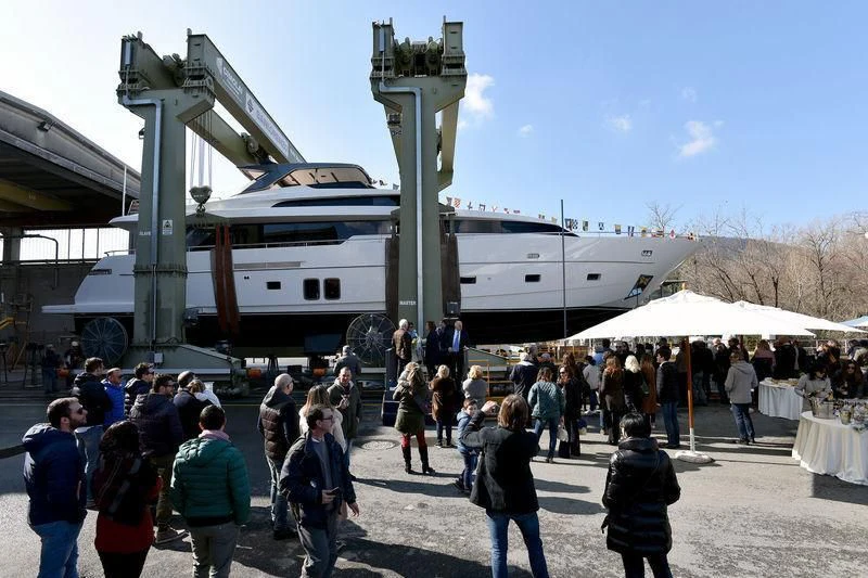 a group of people walking around a large white ship aboard AMAN Yacht for Sale