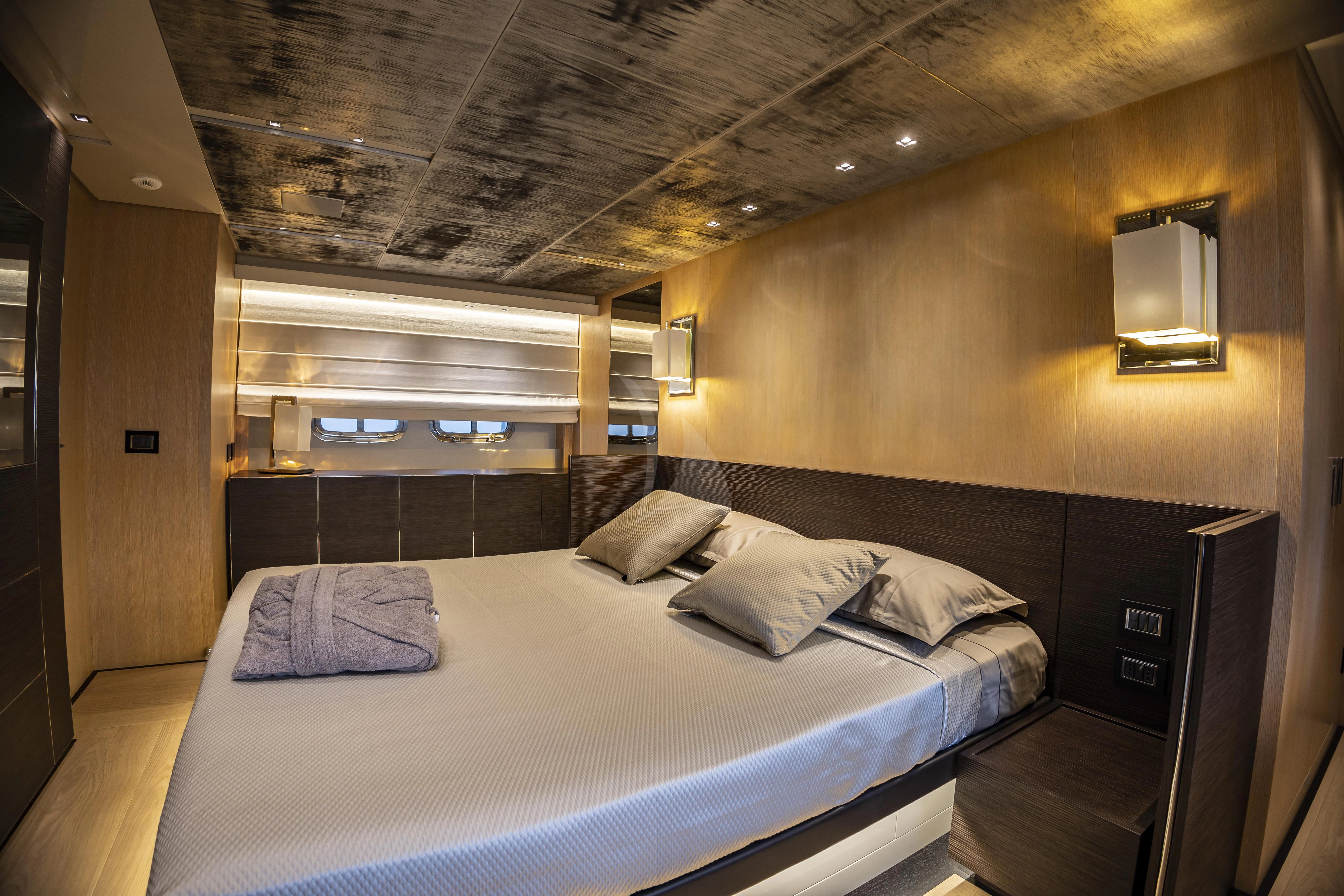 a room with a bed and a mirror aboard AMAN Yacht for Sale