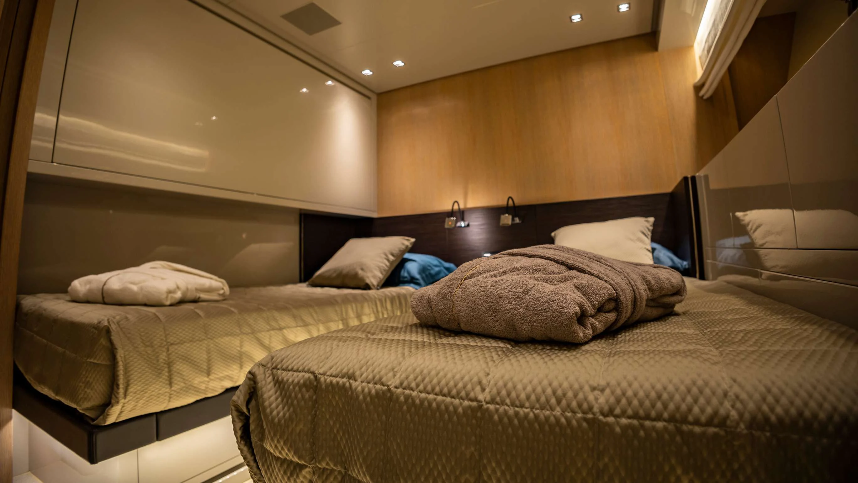 a room with a couple of beds aboard AMAN Yacht for Sale