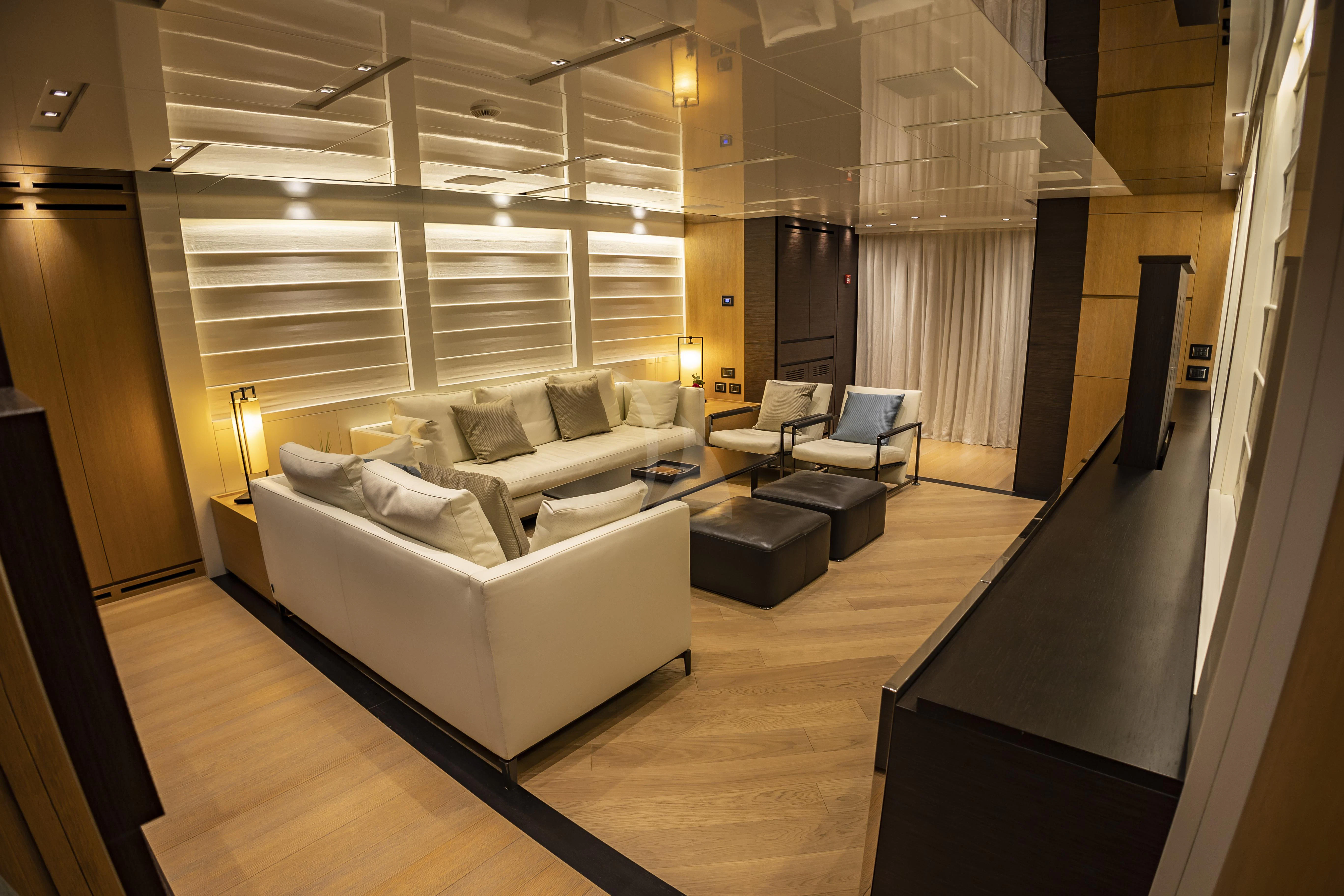 a large room with a couch and a table aboard AMAN Yacht for Sale