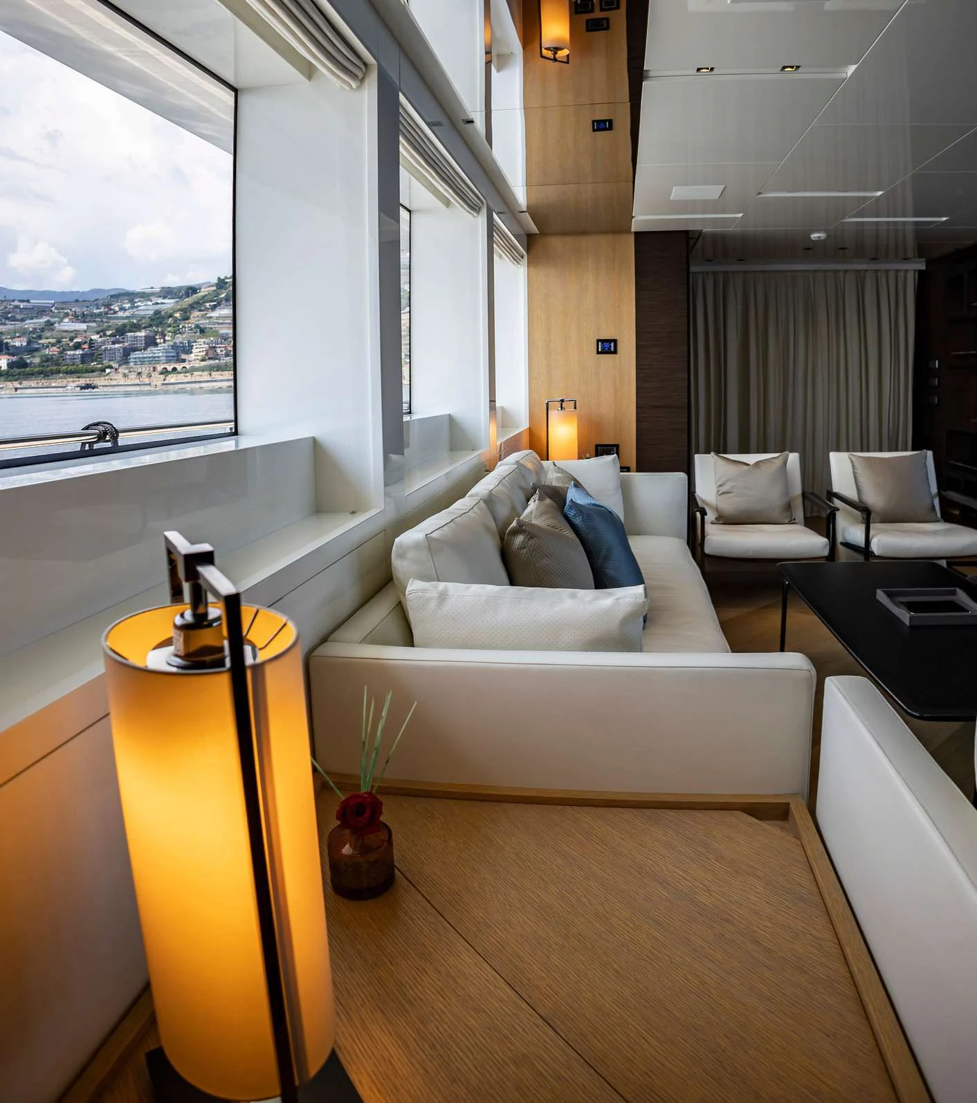 a living room with a large window aboard AMAN Yacht for Sale
