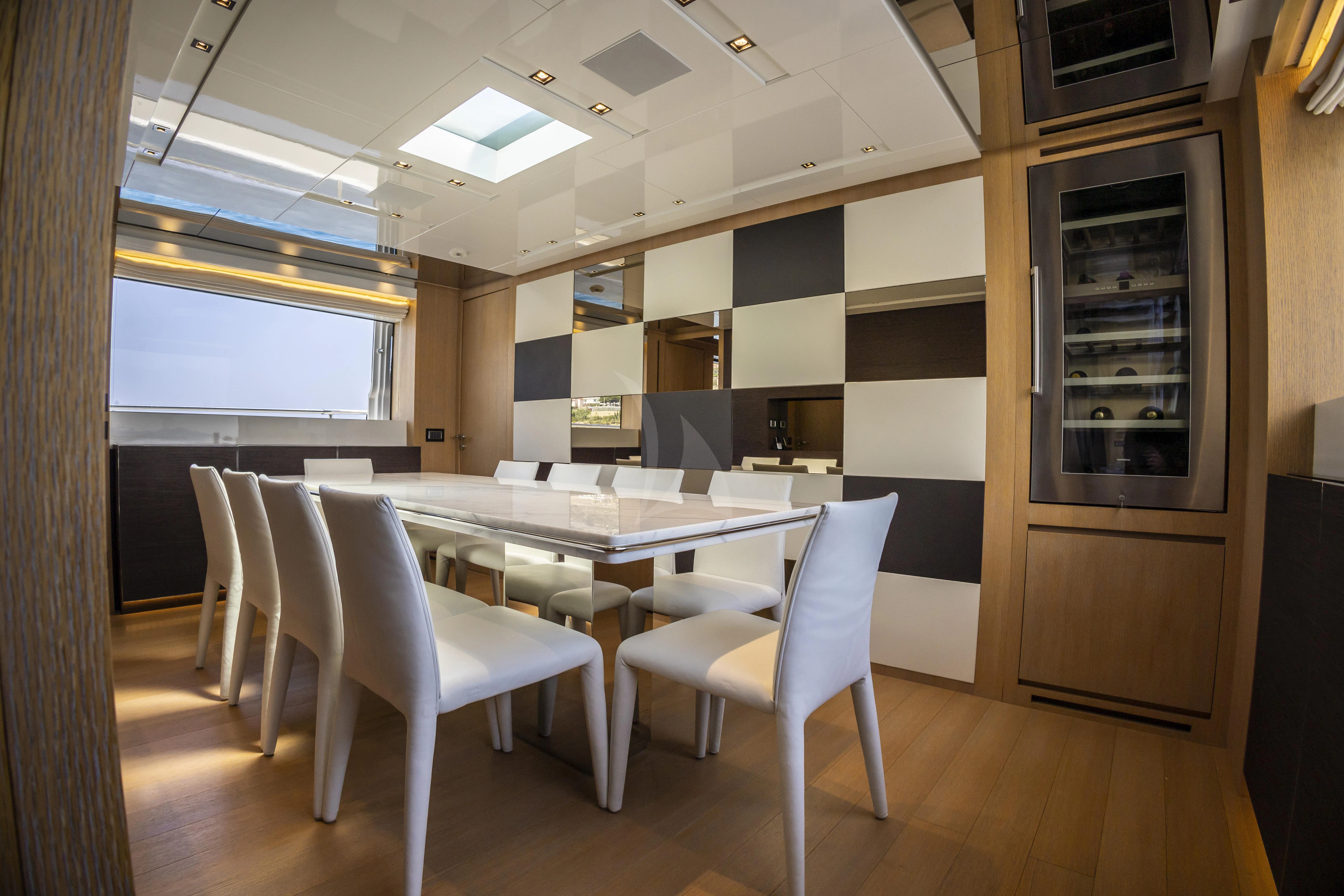 a room with a table and chairs aboard AMAN Yacht for Sale