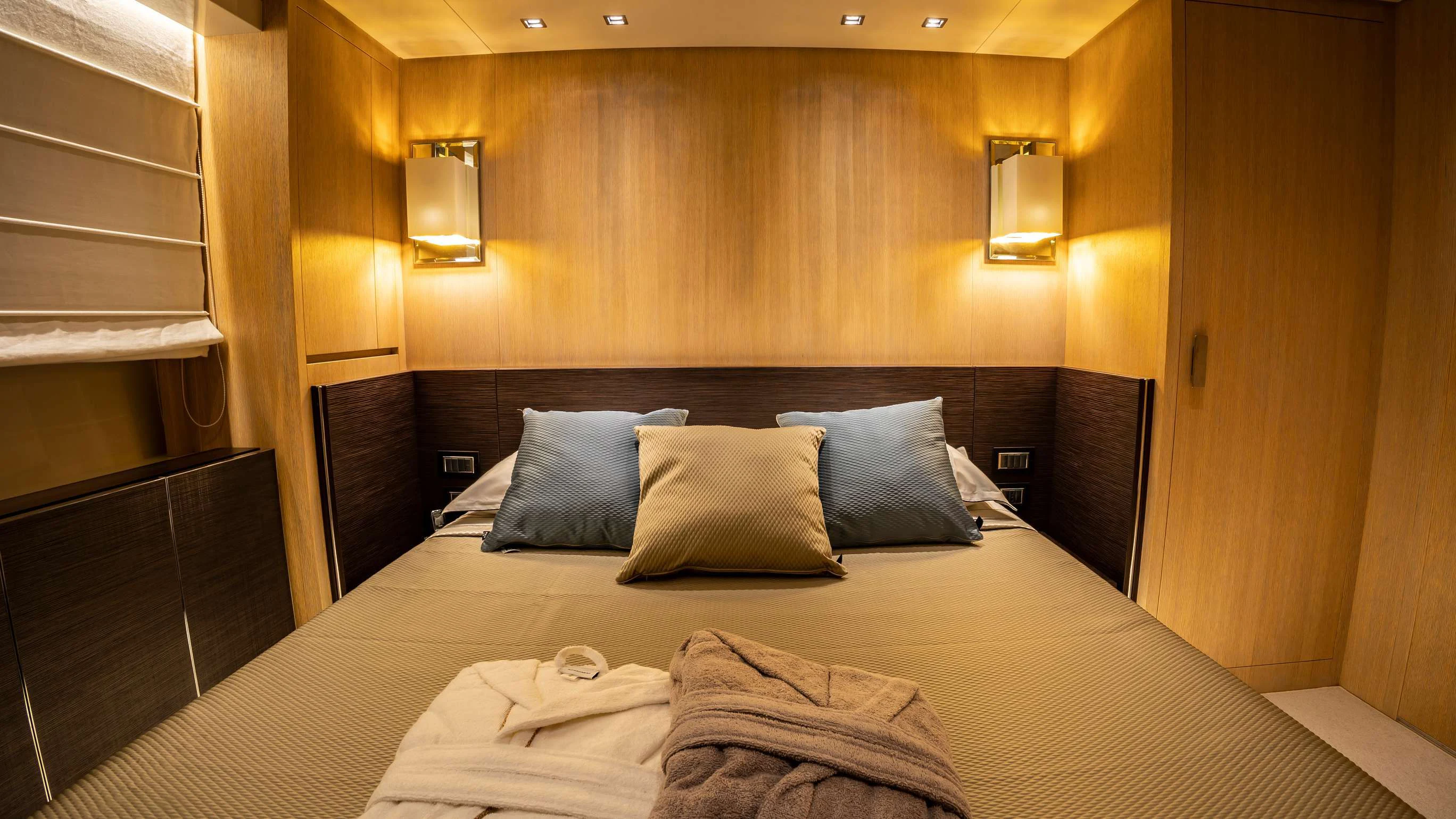 a bed with pillows aboard AMAN Yacht for Sale