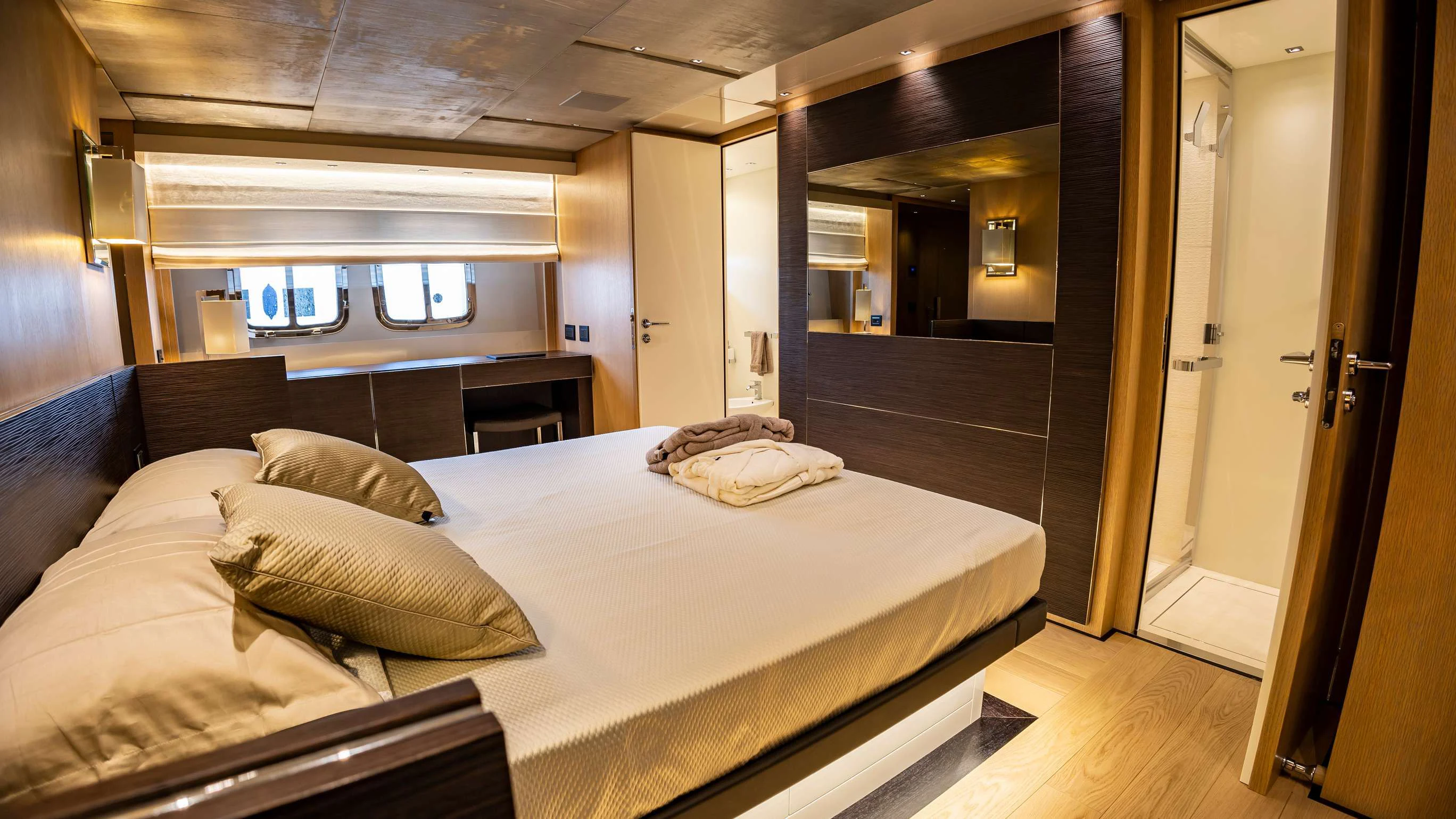 a large bed in a room aboard AMAN Yacht for Sale