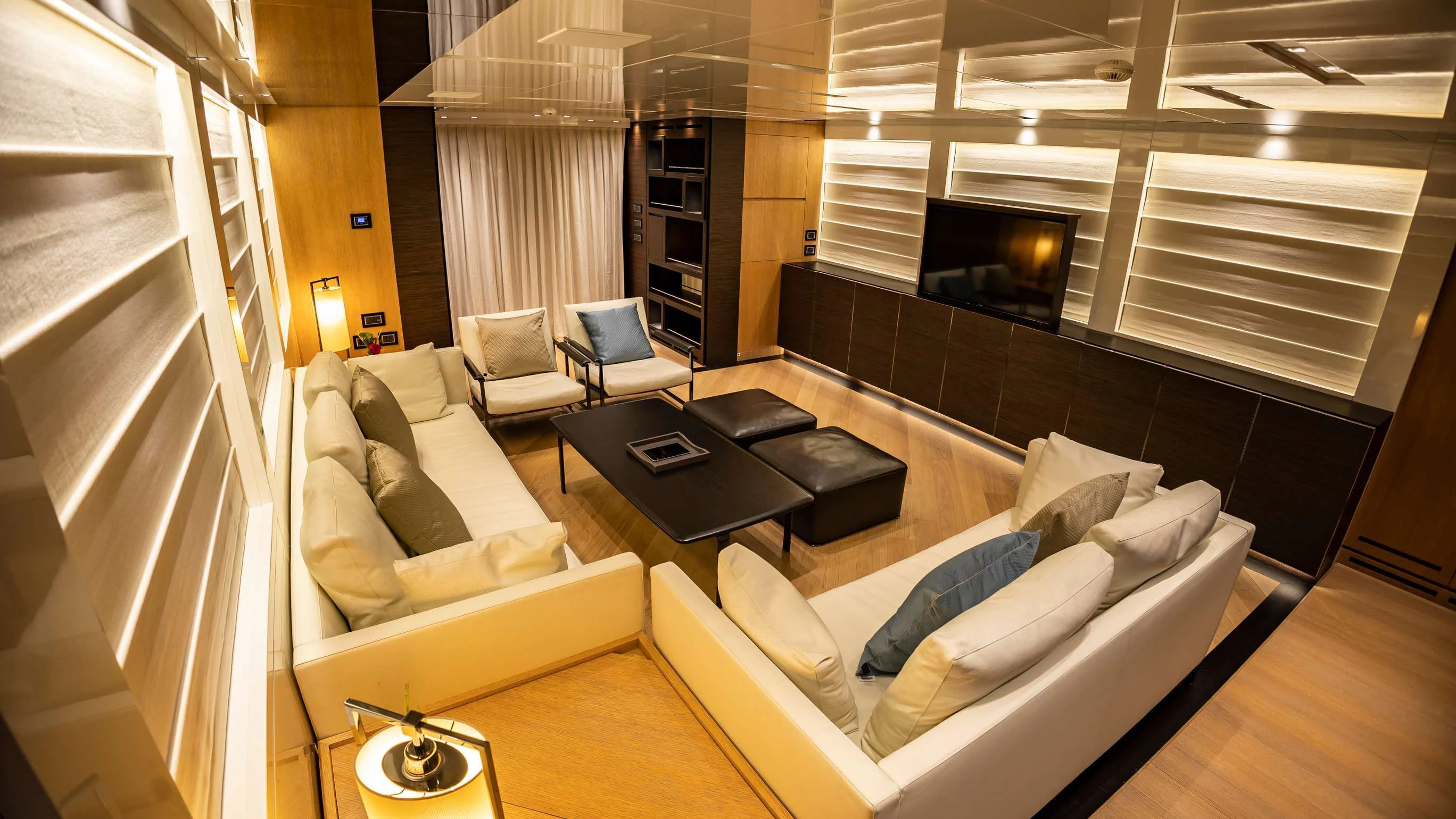 a room with a couch and a table aboard AMAN Yacht for Sale