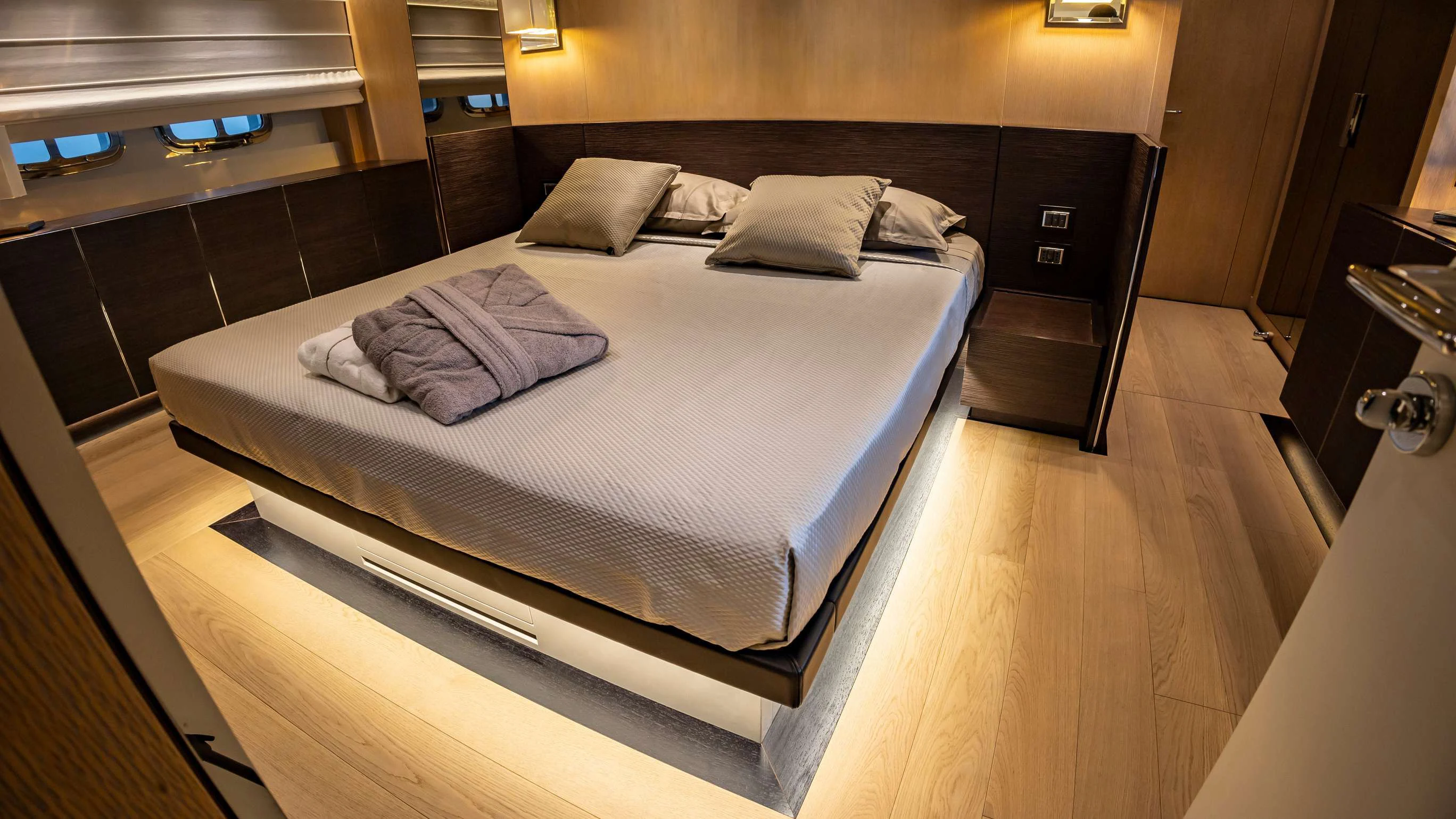 a bed in a room aboard AMAN Yacht for Sale