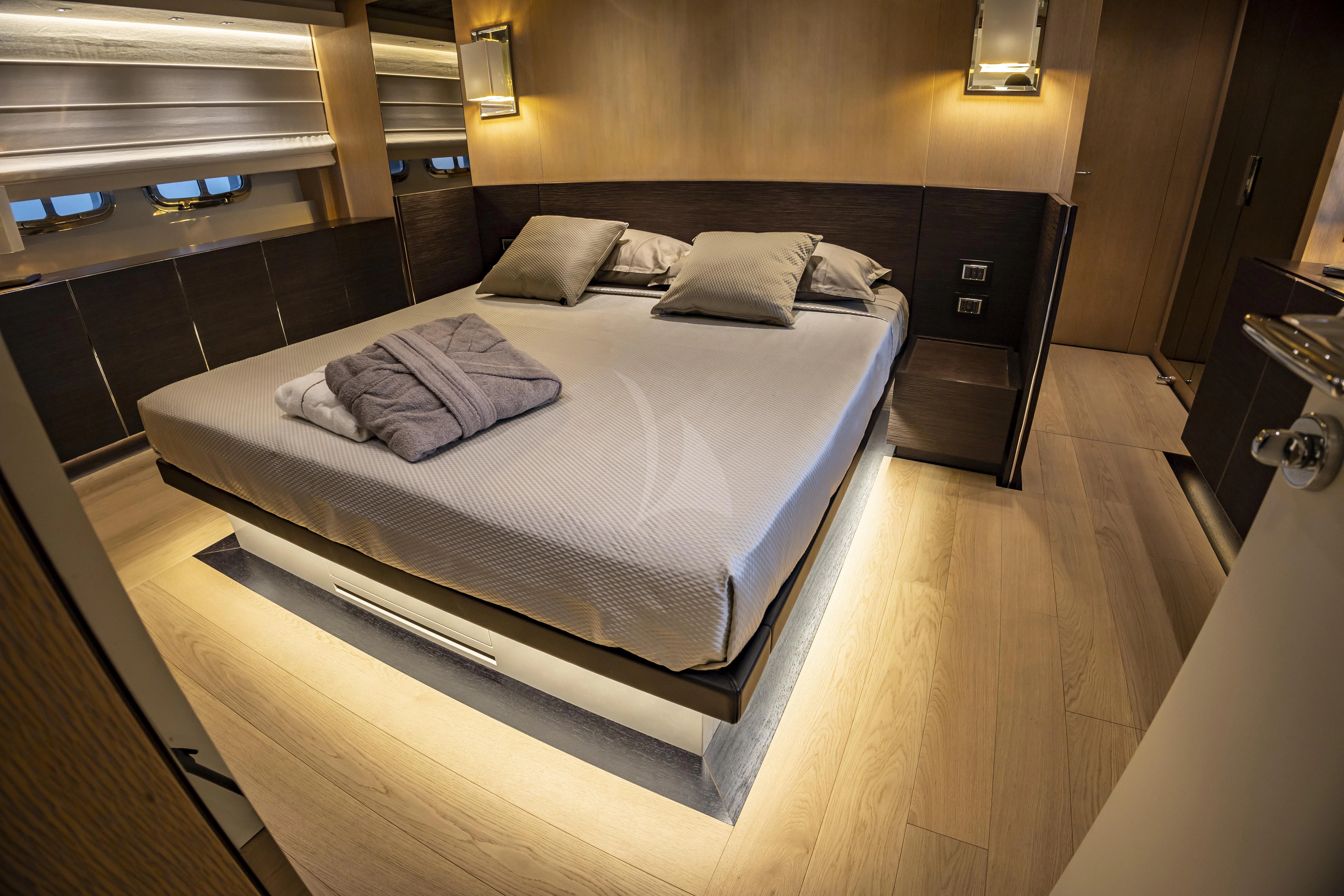 a bed in a room aboard AMAN Yacht for Sale