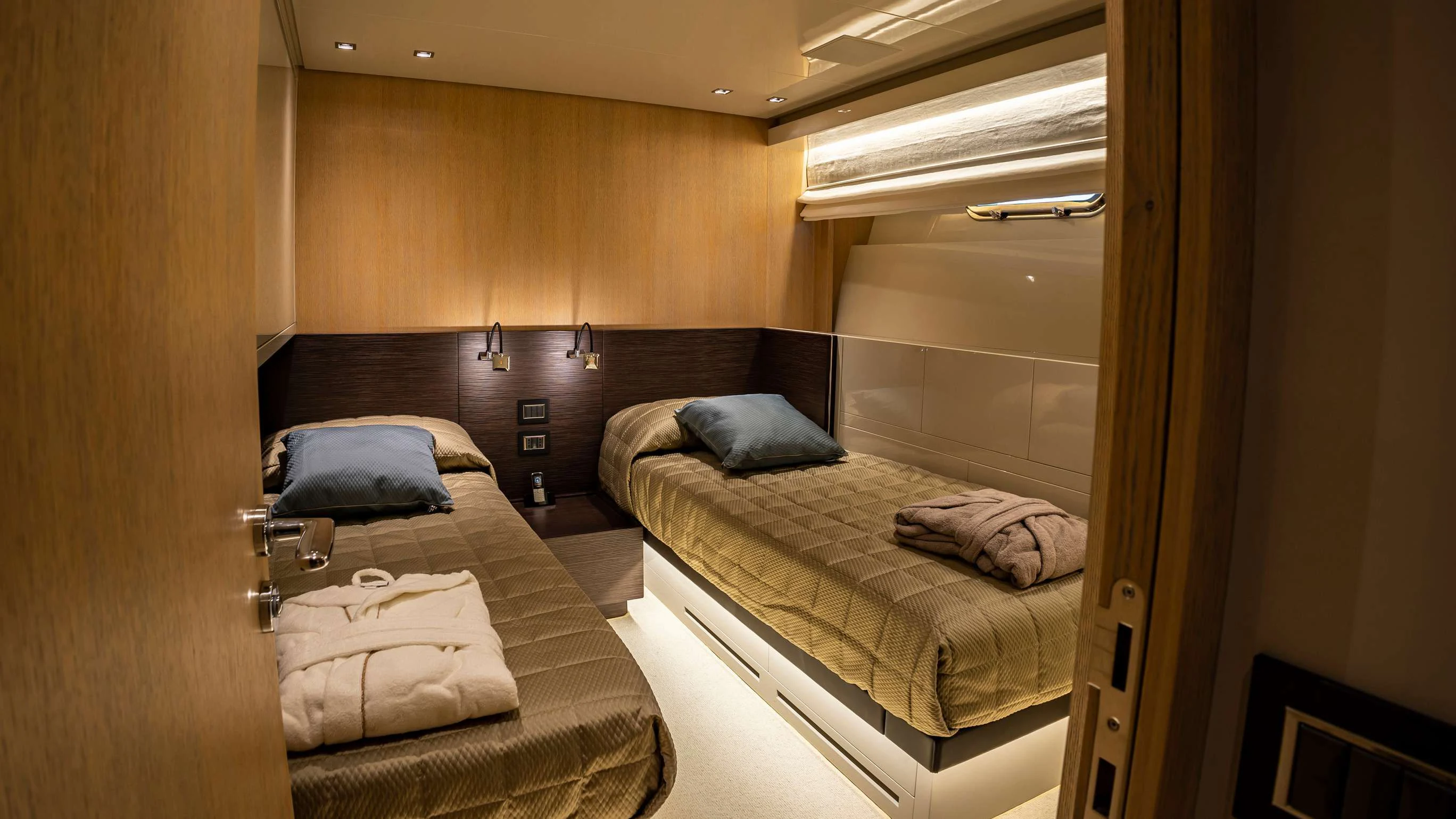 a room with two beds aboard AMAN Yacht for Sale
