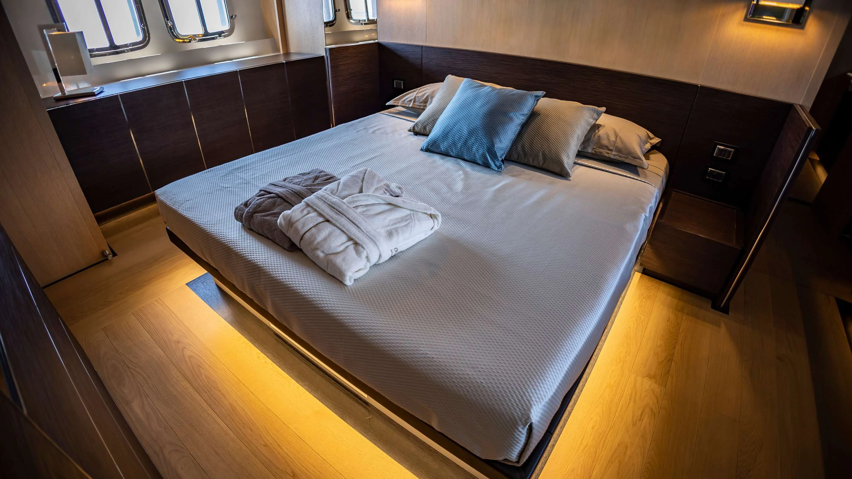 a bed with white sheets aboard AMAN Yacht for Sale