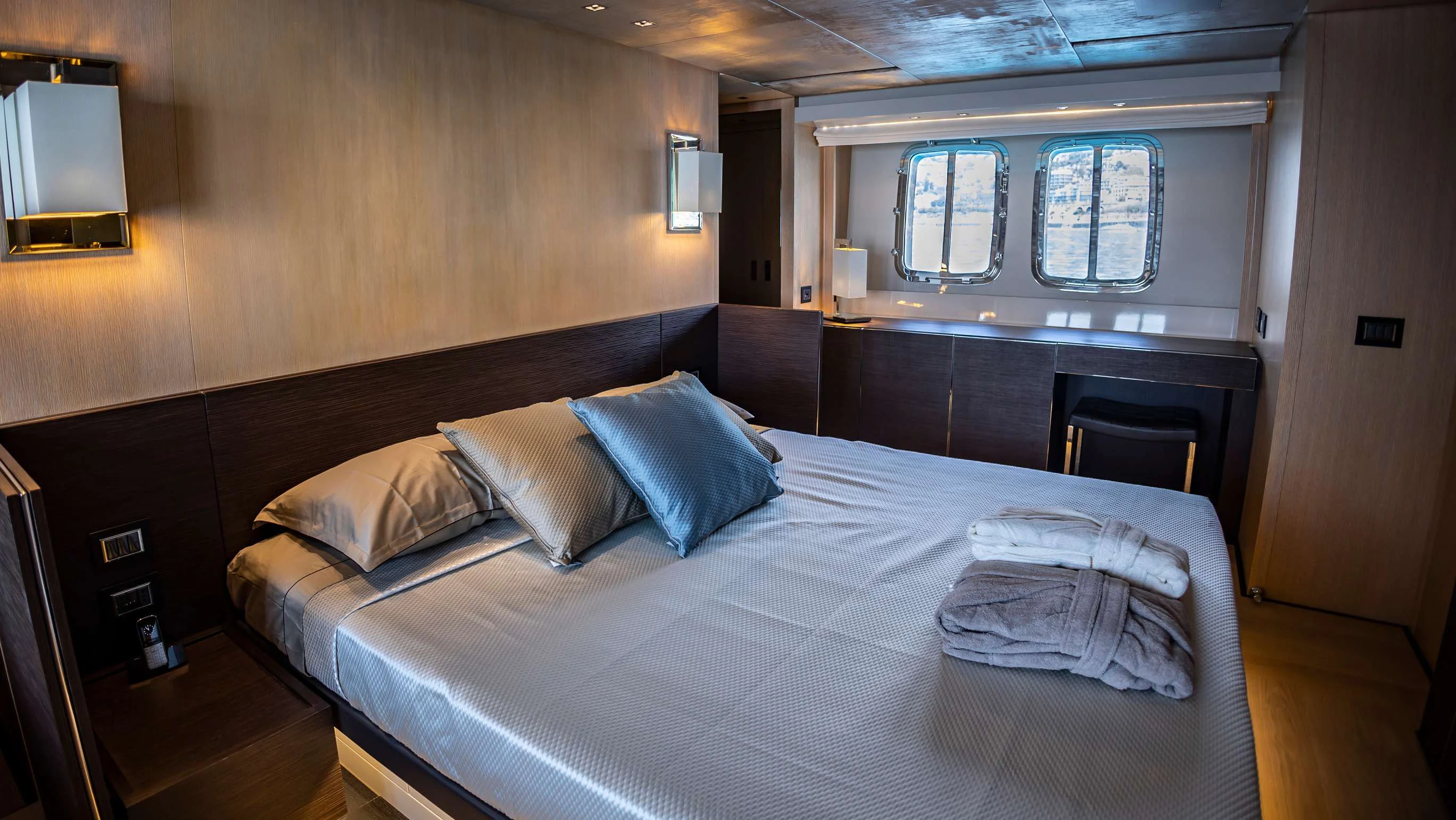 a bed in a room aboard AMAN Yacht for Sale