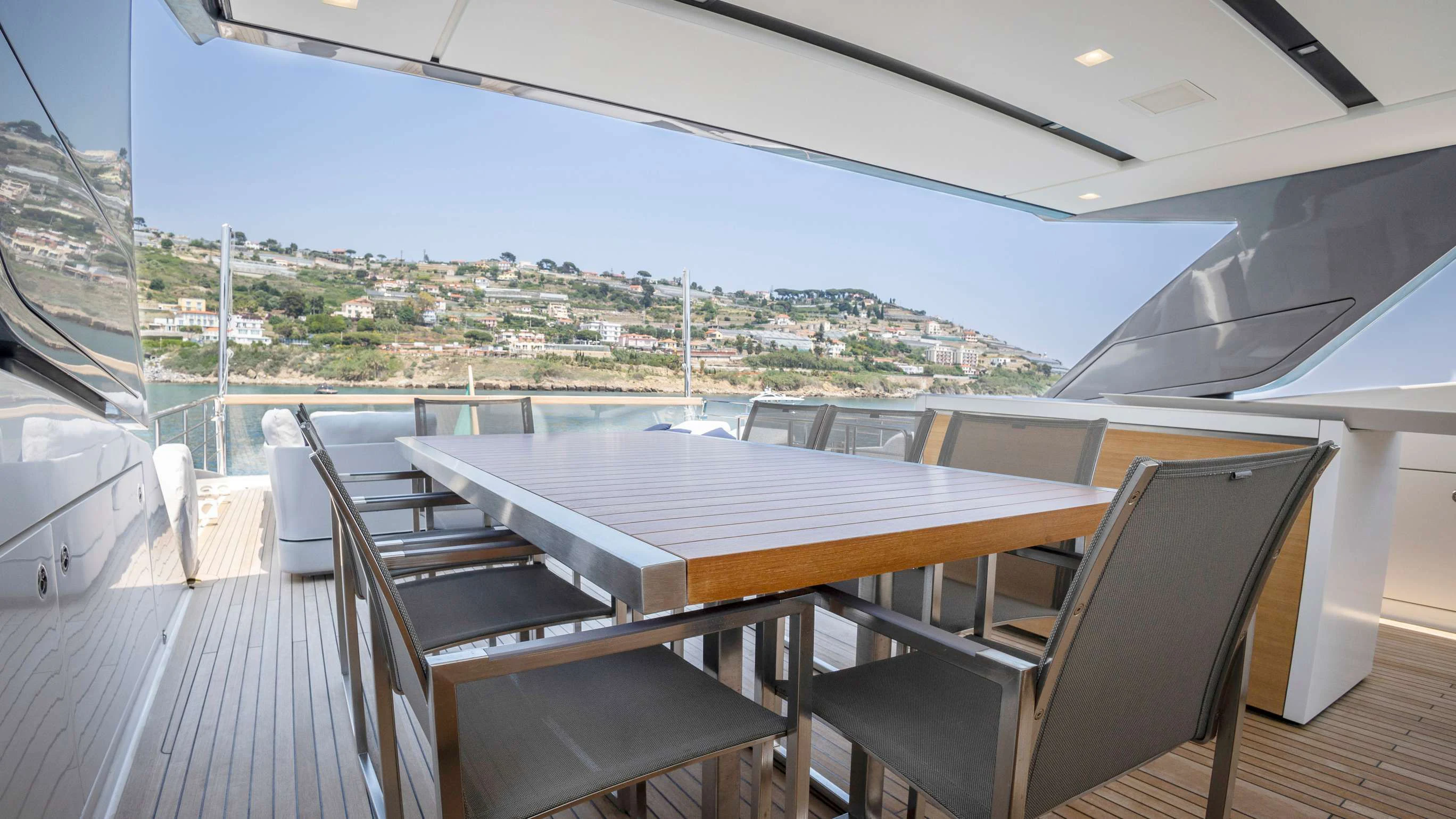 a table and chairs on a deck aboard AMAN Yacht for Sale