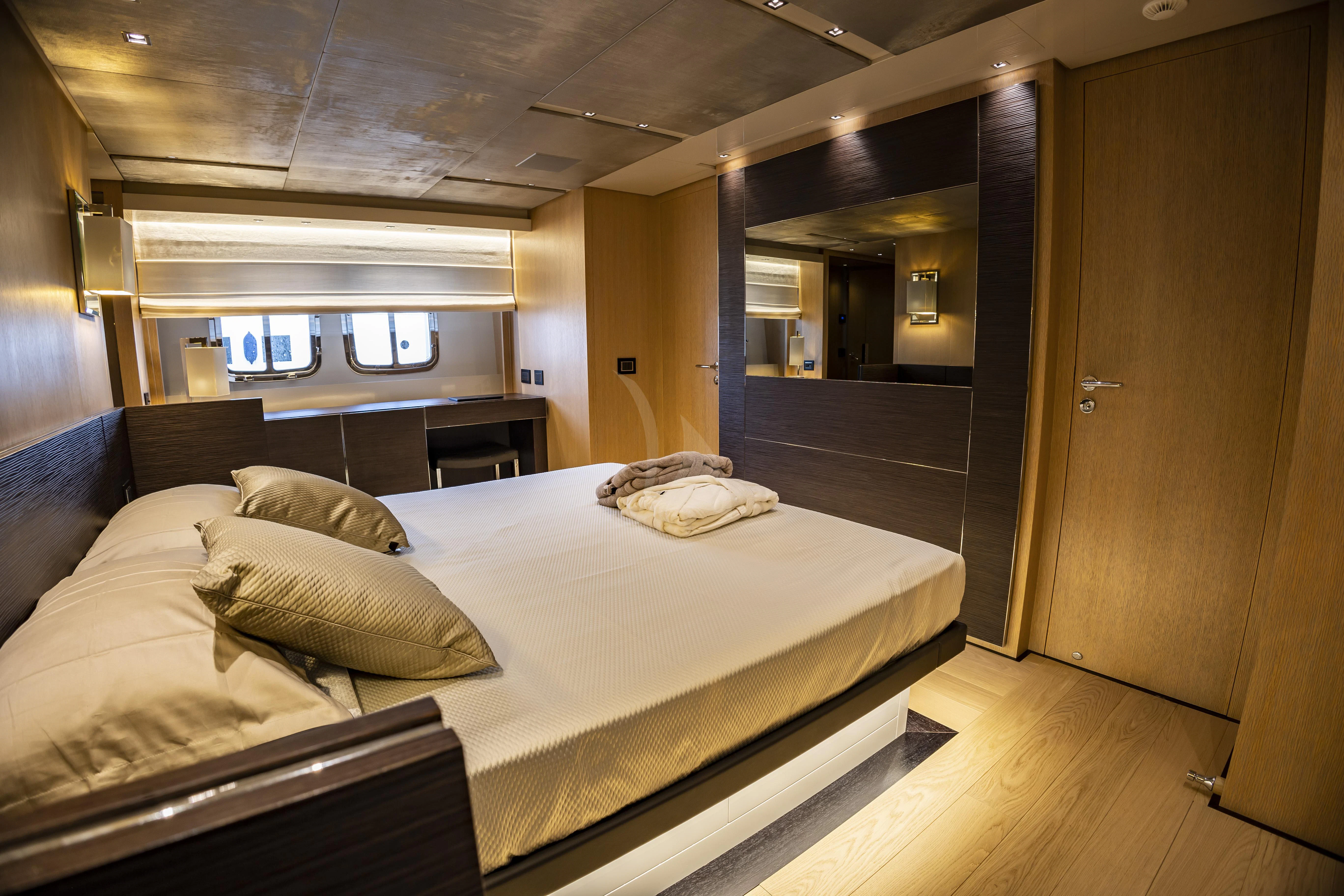 a large bed in a room aboard AMAN Yacht for Sale